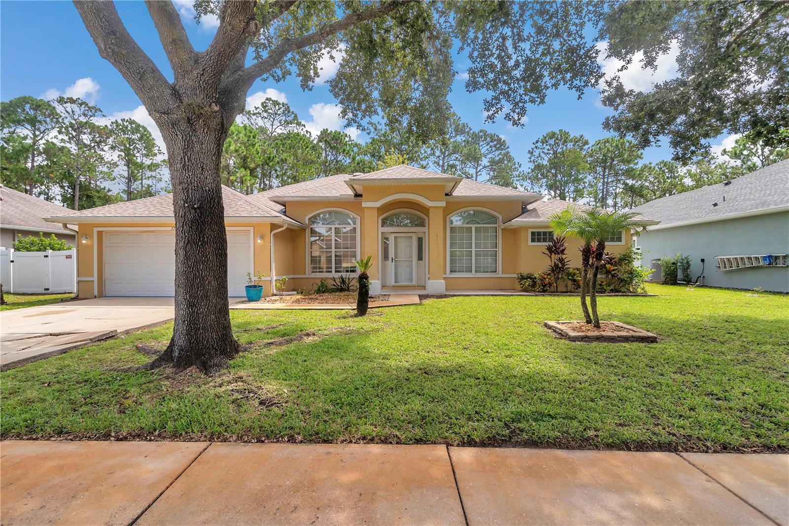 Can you imagine having no power bills? In this beautiful concrete block stucco home in Southern Pines that is a reality! 2025 brand new top-of-the-line solar panels with brand new 2025 30 year architectural roof.Lovely curb with the perfectly positioned palm tree leading to covered front porch with patio. Step through the glass door into inviting foyer with 2019 luxury vinyl plank flooring. To the left is spacious dining room to the right is the potential fourth bedroom or office. Leading straight ahead through the archway is an oversized living room with tray ceilings overlooking the custom paver and fenced backyard. For the ultimate privacy to the right of the home is a perfectly positioned primary bedroom featuring Tray ceiling and a sitting room. Sitting room as view of the backyard as well. Primary bath is Spa like with double vanity, garden, soaking tub and walk-in tile and glass door surround there are two closets in the primary. Leading back across the home you are greeted with a warm kitchen with 2019 stainless steel appliances, plenty of modern cabinets and a bar top island room for 4 to 5 barstools. There is a breakfast area as well overlooking oversized custom paver patio. Just behind the kitchen or the two additional bedrooms and second bathroom perfectly positioned pool potential door leading to the backyard. This bathroom features handicap, grab bars and tile combo shower/tub. No carpet in this beautiful home only luxury vinyl plank and tile flooring. Stepping out of your double sliding glass door from the breakfast area you step outside onto a covered lanai perfect for watching the game on the TV!All electrical including outlets and fixtures 2019. 6 months part of maintenance program.Hot water 2023 and the hvac is a 2008 Trane which is best residential system maintained evry This property has fruit trees, oversize paver patio, and 6 foot vinyl fenced with double gate on the right hand side of the property for easy lawnmower, accessibility. There are 42 solar panels on the roof of the home. This home comes equipped with a solar panel system that offers consistent, predictable energy costs—no surprises as utility rates rise. The buyer will assume the remaining solar loan payments, ensuring locked-in monthly energy expenses while enjoying the benefits of clean, renewable power. The balance is $65,530.01 and the monthly payment is $309.52. All close to the beach!!!!