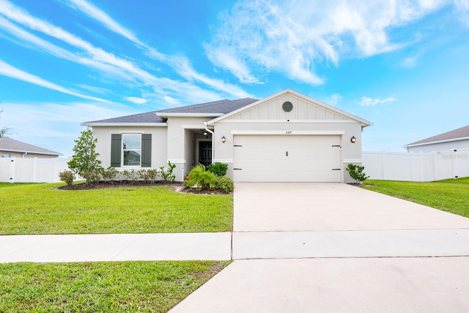 Ask about a lender provided RATE BUY-DOWN CREDIT on this home! ****Welcome to The Gardens at Lake Jackson Ridge where modern comfort and style come together in this 2021 BUILT 4-bedroom, 2-full bath single story home! Set on a spacious .25 ACRE LOT with a PRIVACY FENCED yard, your new home offers room to enjoy both the indoors and out. With LOW HOA fees and thoughtful upgrades throughout, it is truly MOVE IN READY. Step inside to find a bright, OPEN CONCEPT layout designed for today’s lifestyle. HIGH CEILINGS and chic LUXURY VINYL PLANK flooring in the main living areas set a modern tone, while plush carpeting adds comfort in the bedrooms. The SPLIT BEDROOM floor plan delivers versatility and privacy, with plenty of space for both everyday living and future growth. Ideally situated in the heart of the home, the kitchen shines with on-trend finishes. STAINLESS STEEL APPLIANCES, granite countertops, a center ISLAND with bar seating, and a window over the sink that brings in natural light all make this space both functional and stylish. The kitchen flows seamlessly into the living and dining areas, creating an inviting atmosphere for entertaining family friends or a casual evening at home. Sliding glass doors extend the living space outdoors, opening to a SCREENED LANAI that overlooks the fenced backyard. Your PRIMARY SUITE is situated for privacy at the back of the home, featuring a WALK-IN CLOSET and well appointed en-suite bath. The additional bedrooms are all a nice size, offering flexibility for family, guests, or a home office. A HYBRID WATER HEATER provides energy efficiency, while the GARAGE DOOR SCREEN OPTION adds convenience and functionality. Every detail has been well maintained ensuring the home feels fresh and cared for from the moment you step through the front door. With a great location just off Bluff Lake Road, you will enjoy easy access to major roadways keeping you outside of the hustle and bustle while still being close to every convenience. It is an ideal balance of peaceful community living and everyday practicality. If you are in the market for a modern, MOVE IN READY home with space, style and smart upgrades, Ficus Street is ready to welcome you HOME. Call for details on the ASSUMABLE LOAN and schedule your tour!