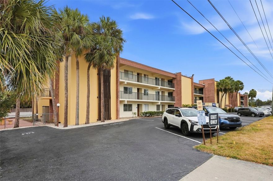 Location, location, location! This beautifully maintained, move-in-ready 2-bedroom, 1-bath second-floor condo in Northeast St. Petersburg offers an exceptional setting just 2.4 miles from downtown St. Petersburg, with convenient access to shopping, dining, I-275, public transportation, the bay and beaches, Coffee Pot Park, and North Shore Park and pool.

Immaculate and thoughtfully updated, the condo features an open-concept living area with built-in bookshelves framing a sliding glass door that opens to a stunning 24-foot screened balcony overlooking lush greenspace—an ideal spot to relax and enjoy the outdoors. Upgrades completed in 2021 include new flooring, a bathroom vanity and fixtures, kitchen countertop and backsplash, a large side-by-side refrigerator, electric stove, and water heater, with the HVAC replaced in 2019.

Additional highlights include an assigned parking space directly in front of the unit, extra storage, and the convenience of a laundry room and elevator just steps from the front door. This well-maintained, non-55+ community offers reasonable monthly fees with no assessments, an onsite manager, and a new roof installed in 2019. Residents also enjoy a canal-front picnic and gathering area with a dock overlooking a peaceful saltwater canal leading to Placido Bayou—perfect for kayaking or simply unwinding by the water—along with a scenic walking and biking path that leads straight to downtown.