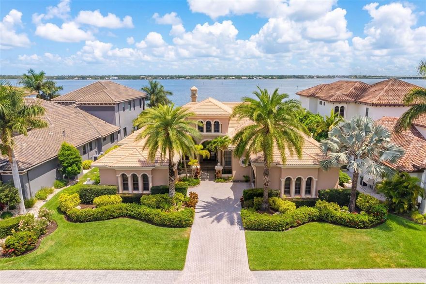 One or more photo(s) has been virtually staged. Within the exclusive gated waterfront community of Hawk Island, 4015 Hawk Island Drive offers a private estate experience with water on both sides, direct boating access, and a setting that stands apart in the Bradenton luxury market. The property features a front deep-water dock and a rear observation and fishing pier, creating two distinct waterfront experiences from one residence. Set along Hawk Island’s private peninsula roadway, the home offers privacy, scale, and protected boating access while remaining close to Anna Maria Island, downtown Sarasota, Lakewood Ranch, private clubs, waterfront dining, and Gulf beaches.
Designed to take full advantage of its surroundings, the residence features expansive living spaces, high ceilings, and walls of glass that make the water views part of everyday living. The floor plan works well for both entertaining and daily life, with an easy flow between the kitchen, gathering spaces, formal living areas, and outdoor terraces. The layout feels open while still offering separation, privacy, and flexibility throughout the home.
Outdoor living is one of the defining features of this property. Multiple covered lanais, elevated terraces, waterfront seating areas, and a pool and spa overlooking the water create a resort-style setting for year-round Florida living. The private dock provides direct access to the Manatee River, Tampa Bay, and the Gulf of Mexico with no fixed bridges, offering true deep-water boating convenience in a protected waterfront location.
The primary suite is designed to capture water views and privacy, while additional bedrooms, guest accommodations, and flexible living areas support multigenerational living, extended visitors, or changing lifestyle needs. Dedicated office and flex spaces add meaningful versatility for an executive workspace, fitness room, media space, or other personalized uses.
Mature tropical landscaping, generous garage capacity, and an expansive driveway approach strengthen the property’s sense of privacy and arrival. The home was designed to complement its coastal setting while offering the security and exclusivity associated with Hawk Island living.
Located near Sarasota, Lakewood Ranch, private aviation access, championship golf, waterfront restaurants, Anna Maria Island, and some of Florida’s most desirable Gulf Coast destinations, 4015 Hawk Island Drive stands apart in the Bradenton luxury waterfront market for its rare dual-waterfront setting, deep-water boating access, architectural scale, privacy, and elevated coastal lifestyle inside one of the area’s most distinctive gated communities.