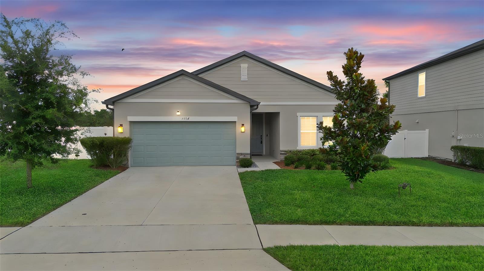 Phenomanally maintained and upgraded property that was just built in 2023 in the neighborhood of Hampton Oaks in the heart of Deltona. Located just minutes from shopping and convenient access to I-4, the location of this property within Deltona is hard to beat! No rear neighbors and a privacy fence is already installed. This 4 bedroom 2 bathroom home features nearly 1900sqft and higher end finishes than most new builds in the area. Upon walking in you will find a spacious foyer, woodlook tile flooring throughout the main living areas, luxury kitchen and a great open concept living space. The Kitchen features Quartz Countertops, Tile backsplash, and a spacious kitchen island with barstool seating. Open to the kitchen and dining area is the living room that features a built in faux stone fireplace and upgraded lighting fixtures throughout the room. Outside you will find a great covered seating area along with plenty of space for different activities. One of the great features outside is the stone and rock walking path along the outside leading you to one of the side fence gates. The floorplan of the home is exceptional with 2 bedrooms and a full bathroom near the front right of the home, the third bedroom separate by itself in the middle left of the home and the primary bedroom towards the back left of the home. The separate bedrooms give a great split concept plan.