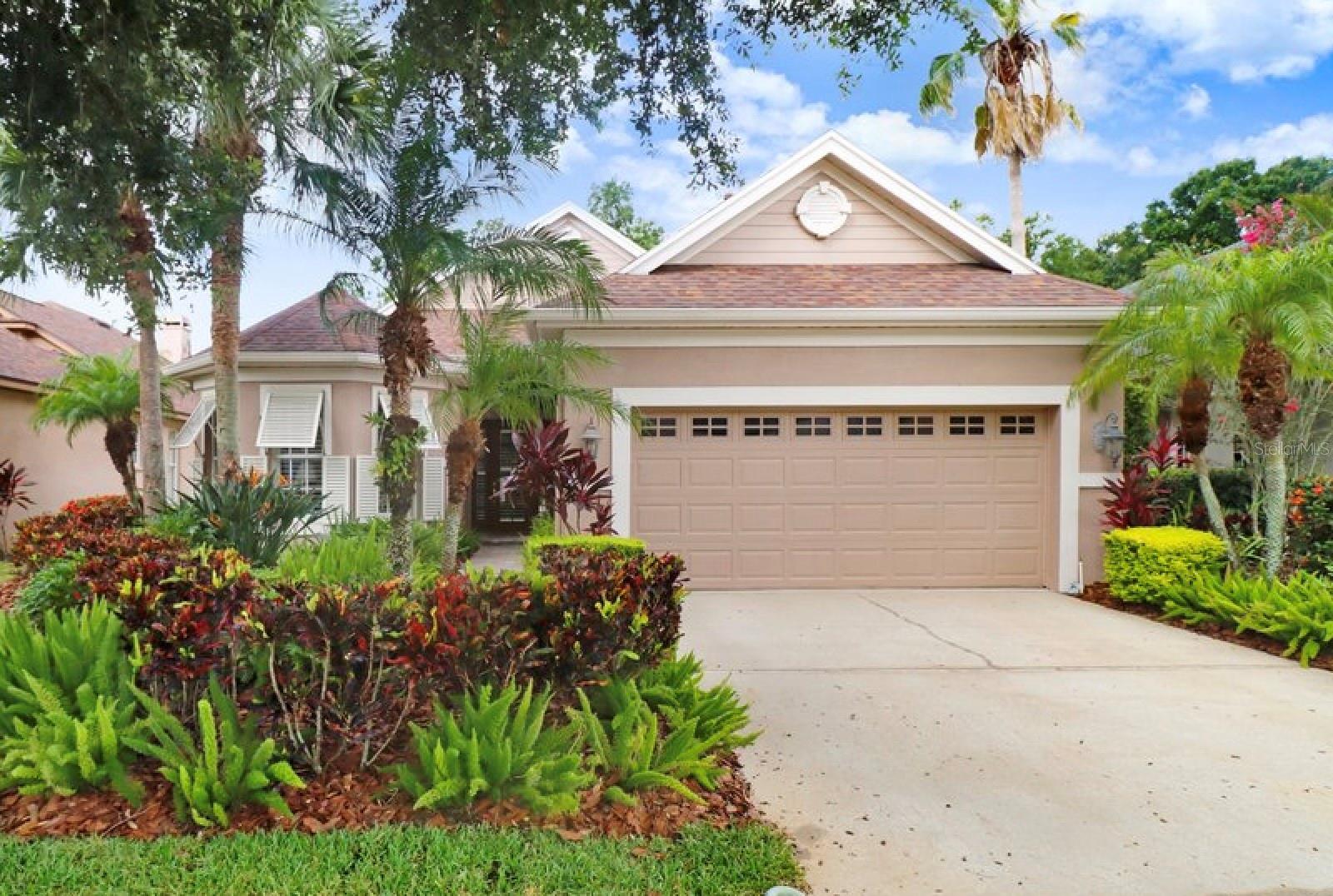 Welcome to this beautifully maintained Arthur Rutenberg 3-bedroom, 2-bath home with a separate study, offering 2,202 square feet of thoughtfully designed living space in The Greens—one of Westchase’s most sought-after 24-hour manned gated communities. Tucked away on a quiet cul-de-sac and nestled on a lush conservation lot, this home effortlessly blends comfort, style, and privacy—along with full access to Westchase’s top-tier amenities, including community pools, pickleball and basketball courts, parks, playgrounds, pavilions, walking trails, golf, and more. Step inside to find volume ceilings and wood-look tile flooring throughout, creating a spacious and elegant atmosphere. Plantation shutters, decorative molding, and refined finishes add to the home’s upscale charm. The open-concept layout flows seamlessly between the living, dining, and kitchen areas—perfect for entertaining and everyday living. The remodeled gourmet kitchen is a standout feature, complete with granite countertops, upgraded cabinetry with decorative trim, and a dedicated bar area ideal for a coffee station or serving guests. A separate dinette nook offers a cozy space for casual meals, with peaceful conservation views as your backdrop. The owner’s suite is a private retreat, featuring a spacious bedroom, dual vanities, a private water closet, frameless glass shower, and a luxurious soaking Jacuzzi tub for the ultimate in relaxation. Don’t miss the secondary bedrooms and full bath thoughtfully tucked away at the front of the home, offering privacy and comfort for family or guests. A separate study provides flexibility for a home office, library, or playroom—whatever fits your lifestyle best. The laundry room is both stylish and functional, with custom cabinetry, granite countertops, and a utility sink offering convenience and extra storage. Step outside through sliding glass doors to your screened lanai, where you’ll enjoy serene conservation views and a saltwater pool, perfect for year-round enjoyment and Florida-style entertaining. Additional highlights include a 2-car garage and a premium location just a short walk to Westchase’s many shops, restaurants, parks, and recreational options. Zoned for top-rated schools and conveniently located near Tampa International Airport, downtown, and the beaches, this home offers unmatched lifestyle and location. Don’t miss this rare opportunity to live in one of Tampa’s most vibrant, amenity-rich communities. Schedule your private showing today and experience the very best of Westchase life.