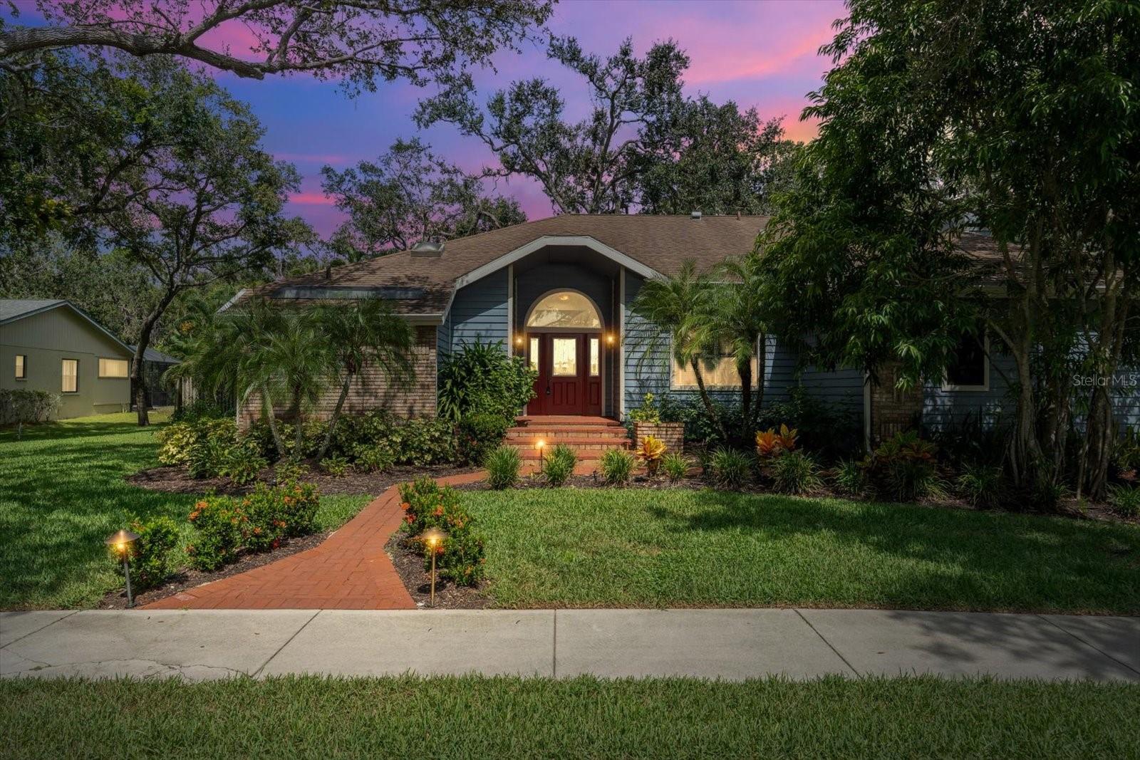 Shaded by majestic oaks on a peaceful corner lot, this Sarasota home combines privacy, comfort, and charm with a split floor plan, granite kitchen, cozy fireplace, and an expansive screened in porch with spa. Step through the front door into a welcoming foyer that leads into the formal dining room, an ideal space for gatherings or greeting guests. Just beyond, the bright and airy living room offers the perfect spot to relax or enjoy a quiet morning, creating a natural flow through the heart of the home, leading to the kitchen and family room combination. Here, granite countertops bring style to a kitchen overlooking the family room, with a gas fireplace that adds warmth and character. The split floor plan ensures privacy, with the generously sized primary suite tucked away from the secondary bedrooms. In the primary bath, sliding glass doors open directly to the outdoors, offering a unique way to start your day or step out for a moment of fresh air. The additional bedrooms are equally spacious, and throughout the home, ample storage means everything has its place. Outside, an expansive screened in porch with a built in spa invites you to relax year round, while the large, shaded yard offers space for gardening, play, or simply enjoying the serene beauty of the mature oak trees. Thoughtful upgrades add peace of mind, including a whole house generator, hurricane rated garage door, UV blue light air purification system in the air ducts, and an irrigation system supplied by a separate well. An additional lot located directly across the street is also available for purchase, offering endless possibilities for the right buyer. Imagine building a guest house, creating a rental property for extra income, or simply securing more space for added privacy. This unique opportunity allows you to purchase the properties separately or as a package deal with the right offer, perfect for multi generational living, investment, or future expansion. Situated on a desirable corner lot and close to Sarasota’s shopping, dining, and stunning Gulf beaches, this home offers comfort, convenience, and timeless Florida charm!