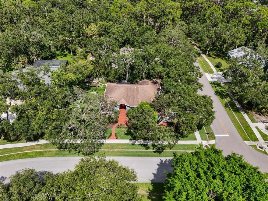 Shaded by majestic oaks on a peaceful corner lot, this Sarasota home combines privacy, comfort, and charm with a split floor plan, granite kitchen, cozy fireplace, and an expansive screened in porch with spa. Step through the front door into a welcoming foyer that leads into the formal dining room, an ideal space for gatherings or greeting guests. Just beyond, the bright and airy living room offers the perfect spot to relax or enjoy a quiet morning, creating a natural flow through the heart of the home, leading to the kitchen and family room combination. Here, granite countertops bring style to a kitchen overlooking the family room, with a gas fireplace that adds warmth and character. The split floor plan ensures privacy, with the generously sized primary suite tucked away from the secondary bedrooms. In the primary bath, sliding glass doors open directly to the outdoors, offering a unique way to start your day or step out for a moment of fresh air. The additional bedrooms are equally spacious, and throughout the home, ample storage means everything has its place. Outside, an expansive screened in porch with a built in spa invites you to relax year round, while the large, shaded yard offers space for gardening, play, or simply enjoying the serene beauty of the mature oak trees. Thoughtful upgrades add peace of mind, including a whole house generator, hurricane rated garage door, UV blue light air purification system in the air ducts, and an irrigation system supplied by a separate well. An additional lot located directly across the street is also available for purchase (MLS# A4661572), offering endless possibilities for the right buyer. Imagine building a guest house, creating a rental property for extra income, or simply securing more space for added privacy. This unique opportunity allows you to purchase the properties separately or as a package deal with the right offer, perfect for multi generational living, investment, or future expansion. Situated on a desirable corner lot and close to Sarasota’s shopping, dining, and stunning Gulf beaches, this home offers comfort, convenience, and timeless Florida charm!