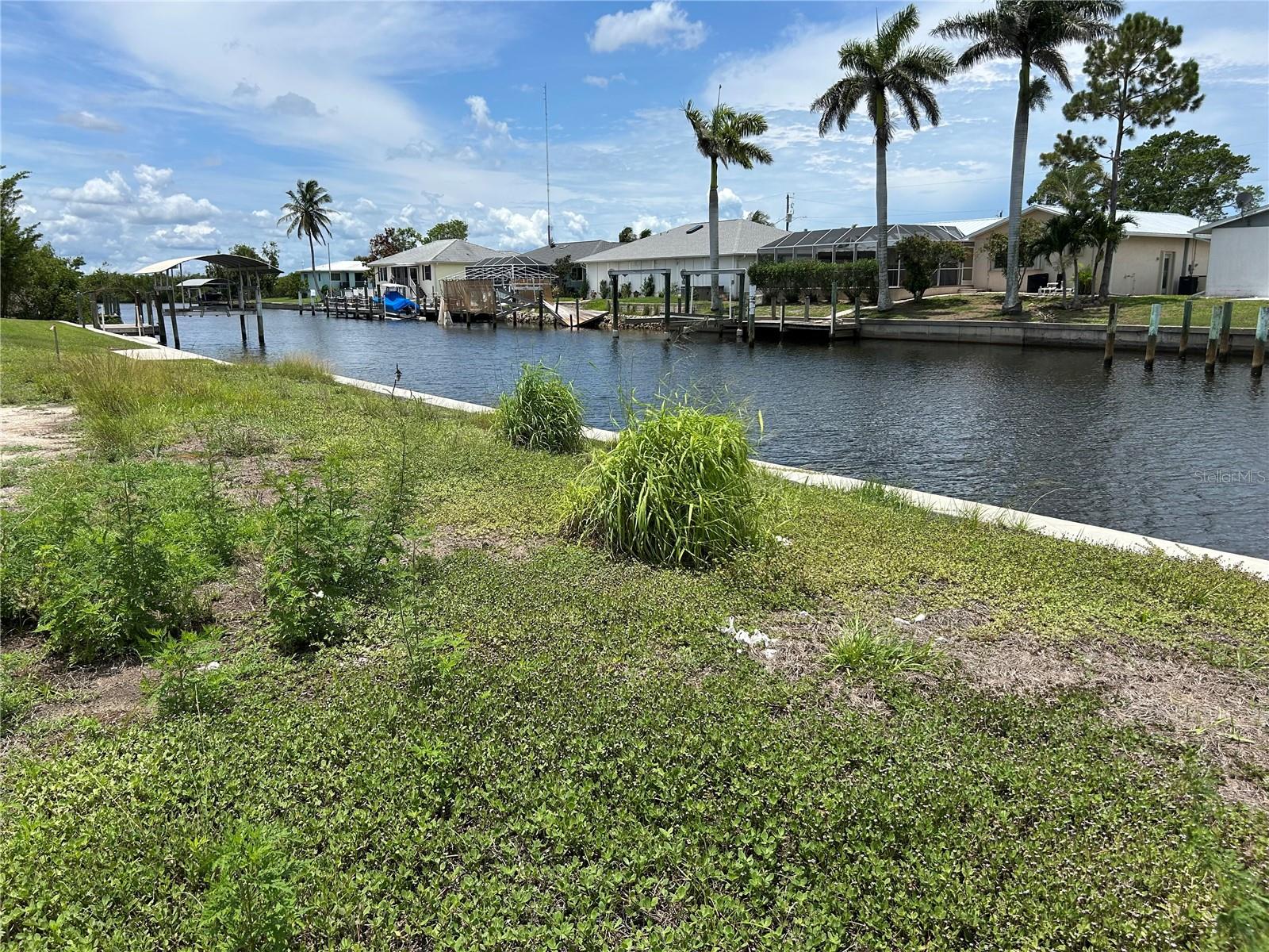 SAILBOAT ACCESS TO CHARLOTTE HARBOR with NEW SEAWALL with LIFETIME WARRANTY! Only 1.9 Miles (15-20 minutes) to Charlotte Harbor. Build your dream home and enjoy beautiful sunsets on this rare find across from new upscale WINDWARD ISLES community. Bring your boat, trailer, or RV. You get the feeling of a prestigious community with NO HOA fees or deed restrictions. A short ride (5-7 minutes) to Punta Gorda Downtown for Dining, Entertainment, and Activities. Sewer hook up available and impact fees partially paid!