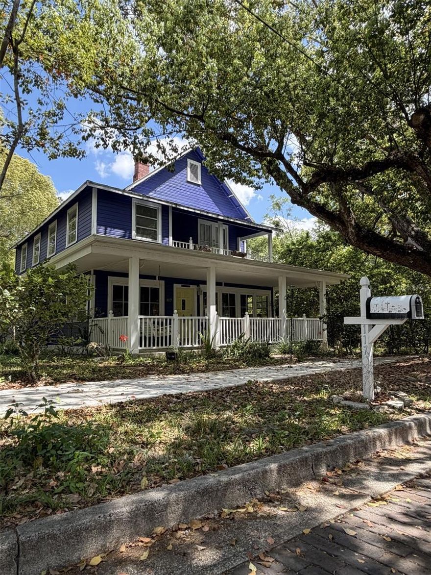Welcome to this charming two-story home set on a spacious 0.41-acre lot with a wraparound porch shaded by mature trees. Inside, an enclosed sunroom leads to a warm foyer with rich wood flooring. The living room offers tall windows, natural light, and a gas fireplace, flowing into a bright dining room with a second fireplace.

The first-floor bedroom provides flexible use, while the nearby bathroom features classic tilework. A large family room with high ceilings opens to the kitchen, which includes generous cabinetry, wide counters, a prep island, and bar seating.

Upstairs, multiple bedrooms include a welcoming primary suite with balcony access. Another bedroom offers wood flooring, a gas fireplace, and its own balcony, while an additional bedroom overlooks the rear patio. Outside, enjoy a covered porch, a lovely in-ground pool, storage sheds, and an expansive backyard with concrete pads. Multiple plants and plenty of space in the backyard for a garden.

Located near Tom Varn Park, Hernando Park, and the Brooksville Downtown District.