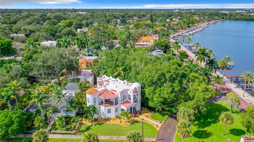 In 1924, C. Perry Snell platted the neighborhood known as Granada Terrace, with circular
plazas and curved brick streets. Today, Granada Terrace, with its concrete monuments and
verdant arbors is one of the most sought after neighborhoods in Historic Old Northeast Saint
Petersburg. A small enclave with a mix of Spanish and Mediterranean Revival homes and
traditional architecture is tucked along the shores of the Coffee Pot Bayou and trail. Steps
away, manatees gather daily in front of Granada Terrace Park and the famously photographed
pink Tabebuia which delights each year with its magical splendor, also resides here. In 2005,
this Mediterranean Revival home was built on a lot with exacting detail to encompass all of the
majestic sights of the area. In 2023, a designers eye updated this beautiful home and brought it
into a modern aesthetic while still keeping the Moorish and Spanish details that give this home
its wonderful character. Every space leads to sweeping views across the park and onto Coffee
Pot Bayou. Entering the home you will notice the polished concrete floors in juxtaposition to
the iron work and arches. The newly designed open concept floor plan highlights the modern,
glossy white kitchen and marble countertops. Repeating arches guide you into the living area
with a gorgeous fireplace and some privacy while still being adjacent to the activities and
provides a guest half bath. The dining area and eat in banquette embrace the panoramic views
overlooking the park and bayou. This fabulous entertaining space opens onto the private
courtyard with a cocktail pool, built in barbecue, another half bath and iron gates that lead to
the much desired two car garage with alley access. Wander up the light filled, winding
staircase to the landing which could be used as an office, play room, or quiet retreat. The
meticulously refinished wood flooring throughout adds a fresh glow to the upstairs. The primary
bedroom has been reconfigured to modern glory. A large terrace with Saltillo tile and Pecky
Cyprus ceiling overlooks the bay. The double vanities and black marble tile give nods to
modern and art deco periods. A soaking tub and stunning walk in shower combine the old and
new aesthetic. A custom walk in closet has been created providing the much needed storage
that is typically missing in older homes. Nicely situated away, but still down the hall are two
more bedrooms with ensuite baths. The laundry is conveniently located on this floor as well.
The newer construction of this home affords higher elevation and the modern desirable
amenities. Some of the many updates in 2023 are a new roof, all pool equipment and pool
remodel, A/C, gas tankless water heater, flooring and much more. Walk or bike ride or kayak
along waterfront trail which winds into downtown St. Pete where dining, sports, markets,
concerts and theatre abound. Truly the best best of both worlds in historic Granada Terrace
and vibrant downtown Saint Petersburg.