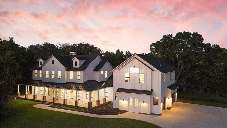 MULTIPLE OFFERS. PLEASE SUBMIT BY 9AM 10/2. Imagine being able to find the unicorn of brand new luxury homes. This extraordinary 5271 sf MODERN FARMHOUSE is tucked away on 6.67 acres of peace and quiet, yet a mere 20-30 minutes from anywhere you would want to be and located in the coveted TRIFECTA of STEINBRENNER, MARTINEZ, & HAMMOND SCHOOLS. So if you are ready for room to spread out, the restful ambiance of the urban countryside, yet convenience galore, this is for you.  Located at the end of a small 5 home cul-de-sac, this one of a kind, custom floor plan was uniquely designed with architectural details to seamlessly blend graceful living together with a private pond and conservation setting. The stately exterior is enhanced with deep wrap around brick verandas highlighting both the front and rear of the home creating extra spaces to sit and relax, or to enjoy your heated salt water pool and spa, sun shelf and fountains with a view you only share with the deer.  When you walk through the front door, the hassles of the day will evaporate as the sheer volume of the rooms allows you to take a deep breath. The large foyer welcomes you to the split layout, open plan graced with the highest quality upgrades and designer curated finishes that weave together texture, color palette, and design features worthy of an Architectural Digest spread. The two-story living room with beamed ceiling, walls of windows, brick accents continued inside from the veranda, a fireplace, cabinets, and French doors to the pool area flows into the next level Chef’s dream kitchen.  Here is the heart of this home where your memories will be made as you gather family and friends around the large island, enjoy laughter, special moments, and cherished holidays. The details make it easy including the Italian Hallman 48” double oven dual fuel range with 6 burners plus center griddle/grill, vented range hood, Big Chill state of the art refrigerator, Fisher & Paykel double drawer dishwasher, TWO country sized sink prep areas, oodles of custom 42" shaker soft close cabinets, and stunning sleek quartz countertops. Peek around the corner and find the walk-in pantry providing all the extra storage you need.  The first floor primary suite is equally charming with pool access, tray ceiling, recessed lighting, dual walk-in custom closets and FABULOUS ensuite bath with dual sinks, custom cabinetry, freestanding tub, GIANT walk in shower featuring rain head, Euro glass and mosaic floor.  The second floor has a generous loft, 3 guest bedrooms, 2 full baths and a fun hideaway.  Need more space?  We have it.  Walk through the reclaimed brick floor mudroom and up the stairs to discover that above the oversized 3 car garage, there is a large bonus/game room and office area with full bath, perfect for a home office, exercise, or theater room. It could even be a 5th bedroom/living suite with a few minor adjustments. More WOW features include a gorgeous dining room, unique lighting fixtures, beautiful millwork, porcelain tile plank floors throughout, 8' interior solid core doors, impact windows, two Navien tankless instant water heaters, three Goodman HVAC units and much more.  This beauty has been pre-inspected, professionally cleaned and is brand spankin' new with builder warranty, ready for you to live your best Florida life. NOTE: Ask your Realtor for the new construction comps from the same builder within 1/4 mile, in Realtor notes.
