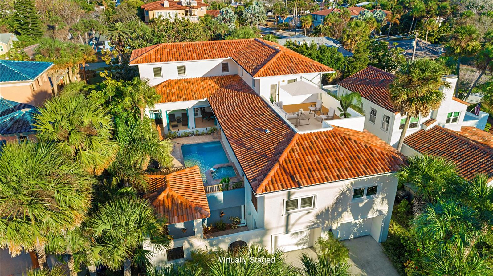 One or more photo(s) has been virtually staged. One or more photo(s) have been virtually staged. LUXURY COASTAL RETREAT- ACROSS FROM BEACH ACCESS TO THE GULF. TURNKEY FURNISHED INVESTMENT OPPORTUNITY, PRIMARY RESIDENCE OR VACATION HOME. This 3971 sq ft POOL HOME is steps from the powder-soft sands of Clearwater Beach. Boasting 6 spacious bedrooms and 8 bathrooms, this courtyard-style retreat comfortably accommodates up to 20 guests. Beyond the ornate wrought iron entry on the first level, guests are welcomed by a tranquil outdoor foyer and cascading fountain- the first of many elegant touches. Ascend to the expansive second-floor sundeck, where a private heated pool and spa with a waterfall create the ultimate outdoor oasis. The space is wrapped in covered patios for lounging, complete with motorized electric screens for added comfort and privacy. A poolside full bath adds convenience for entertaining. Enter through French doors to soaring ceilings and designer finishes that set the tone. The chef’s kitchen is a showstopper, featuring a granite island, sun-filled skylight, endless maple cabinetry, stainless steel appliances, a gas stove, and pantry — all designed for effortless entertaining. The open-concept living and dining area features a dramatic wood-plank ceiling and custom built-ins, along with French doors to the covered patio. A spacious media room, wired for surround sound, features a tray and coffered ceilings, creating a soothing ambiance that enhances the entertainment experience after a beach day. All 6 bedrooms have en-suite bathrooms. The primary suite is a serene sanctuary with pool views, dual vanities, 3 backlit LED mirrors, a custom walk-in closet, a bidet, and a large shower. A second master suite is truly an In-law suite because it includes a large walk-in closet and space for a den or home office. The 1st-level dormitory-style suite comfortably sleeps six, while three additional bedrooms on the third floor provide ample room for multigenerational living or group getaways. As the sun sets, gather on the rooftop terrace for panoramic Gulf views and unforgettable Florida sunsets. Additional features include a 4-car tandem garage with space for a boat, golf cart, and guest vehicles. The home also features luxury vinyl plank & Berber carpet, plantation shutters, a tankless water heater, water softener, security and surveillance system, wind-rated windows, and a central vacuum. This turnkey home is ready for immediate occupancy or rental income. Rental History Available. This home is just a 5-minute golf cart the Clearwater Pier, restaurants, and shops. Easy access to Tampa Intl. and St. Pete-Clearwater airports (30 minutes). Whether you're hosting extended family, offering premium vacation rentals, or simply indulging in the Florida lifestyle, this one-of-a-kind architectural type design coastal compound delivers unmatched flexibility, elegance, and value across from the Gulf Coast. Shown by private appointment. Floor plan available. Buyer to verify all measurements.