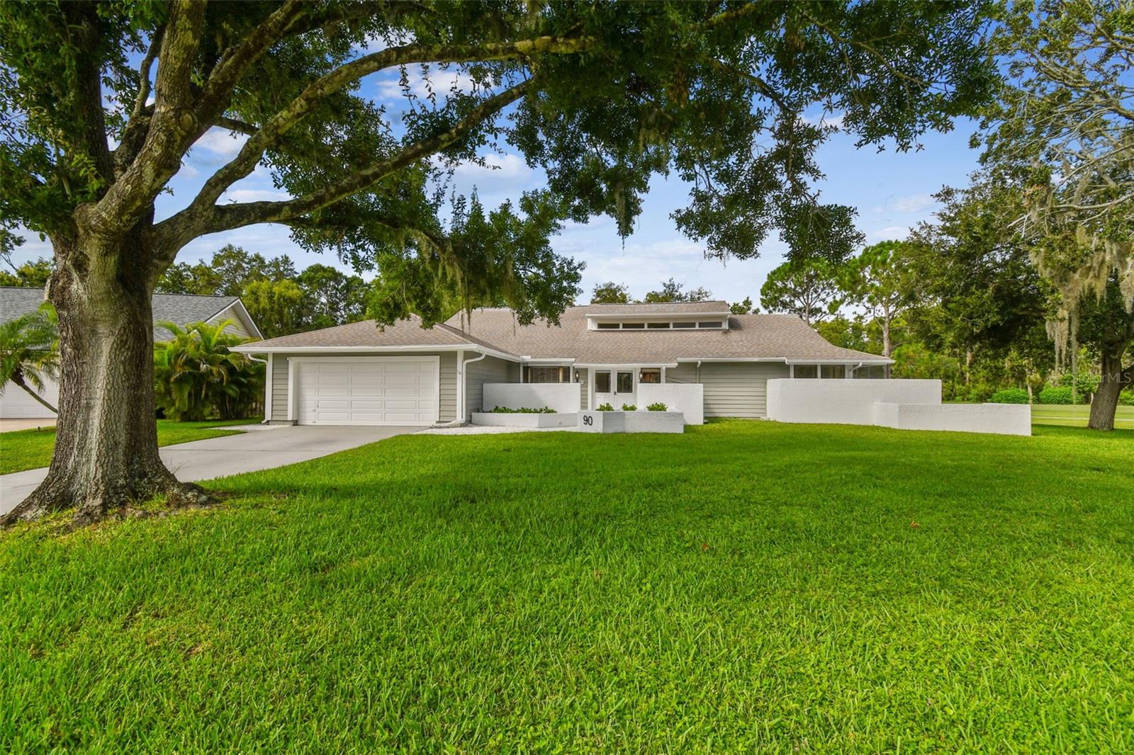 Tucked at the end of a quiet cul-de-sac on one of the most spacious and serene lots in East Lake Woodlands Estates, this thoughtfully updated 4-bedroom, 2-bath pool home offers seamless one-level living and private golf course views—all set against a tranquil backdrop of wooded preserve and nature. With .37 acres of fenced, landscaped grounds and a prime location overlooking the 5th hole of the South Course at Ardea Country Club, the home balances connection to the game with peaceful distance—close enough to enjoy the view, yet set back for quiet and privacy. Watch for native wildlife including deer and woodpeckers from your screened lanai, or entertain by the pool with ease thanks to a covered bar and multiple indoor-outdoor access points. Inside, vaulted ceilings and abundant natural light enhance the open layout. The kitchen—beautifully refreshed in 2022—features quality cabinetry, a custom backsplash, granite counters, and stainless steel appliances, opening directly to both dining and living areas for effortless gatherings. A decirative fireplace adds charm to the secondary living space. The spacious primary suite feels like a private retreat, with direct access to the pool and a spa-style bath complete with quartz dual vanity, a walk-in shower, and a freestanding soaking tub nestled beside a walled courtyard—blurring the line between indoors and out while ensuring total privacy. Three additional bedrooms, an updated guest bath, and an oversized laundry room offer flexibility and function. Notable upgrades include new porcelain plank tile flooring (2025), a new dishwasher and hot water heater (2025), a black aluminum perimeter fence with oversized gate (2023), and a resurfaced pool. The roof was replaced in 2016. Located in an X flood zone with no history of storm-related damage.Current 4-Point and clear Termite letter for 2025 provided by seller. East Lake Woodlands Estates is a guard-gated community offering optional access to the private Ardea Country Club, with two championship golf courses, tennis, pickleball, a spa, fitness center, and dining. Convenient to top-rated schools, airports, beaches, shopping, and dining—this is the best of Florida living, right at home.