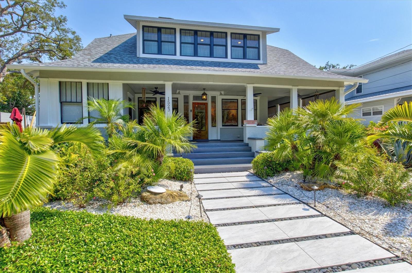 Immerse yourself in the rich history and timeless elegance of this meticulously renovated historic home located in the heart of Point Pleasant in downtown Bradenton. This distinguished two-story, 4-bedroom, 5-bathroom American Four Square home offers a harmonious blend of classic architectural charm and contemporary luxury. Originally built in 1913, the Betts House stands as a testament to Bradenton's storied past, with every detail meticulously preserved and enhanced for modern living. The newly landscaped front yard leads to the inviting, large wrap-around porch evoking a sense of nostalgia, reminiscent of days gone by. The grand living area has the original leaded windows with a fireplace and leads to both the family room and kitchen. The spacious family room has impact windows and a convenient full bath with the stairway leading to the four bedrooms and four additional baths. The remodeled kitchen and dining area is an open and inviting space overlooking the side yard. Crafted with care, the kitchen features impact windows, KraftMaid cabinetry, new LG appliances, a Bosch paneled dishwasher, exquisite butcher block counters, and complemented by an island topped with Dekton Entzo quartz. The large dining area still has the vintage leaded windows and leads to the impressive added butler's pantry that was formerly a side porch. It offers a wine refrigerator, two refrigerated drink drawers, a sink, and additional cabinetry also with Dekton Entzo quart. This area offers a seamless transition between indoor and outdoor entertaining. Once upstairs, you will find three bedrooms with three remodeled ensuite baths and a fourth bedroom serviced by an updated hall bath. The added primary bath has a spacious walk-in shower, dual vanities, and a private water closet. Step outside and discover a private oasis, complete with a composite side deck, rebuilt back porch, and a partially submerged 15'x8'x5' dual swim jet lighted Swim Spa. Practice your putting skills on the professionally installed 4-hole putting green, surrounded by lush artificial turf and expertly landscaped gardens. After a busy day, relax by the gas fire pit or rinse off in the outdoor shower before your resistance swim. Enjoy privacy with new bamboo fencing and landscape lighting, while the addition of string lighting illuminates the side yard for enchanting evenings under the stars. Thoughtful updates include a new roof in 2022, replacement of both HVAC units (downstairs unit 2025, upstairs unit 2023), 16 new impact windows, and a complete refinished and staining of wood floors, stairway, and handrails. In addition, the interior has been freshly painted and has new light fixtures and new window treatments throughout. Perfectly situated a very short distance from historic Old Main Street with its charming shops, bars, and restaurants as well as the marina, Manatee River, and the Riverwalk. The Betts House offers unparalleled access to the best of Bradenton’s waterfront living. Experience the perfect harmony of history and modern comforts by discovering the timeless allure of this exceptional residence.
