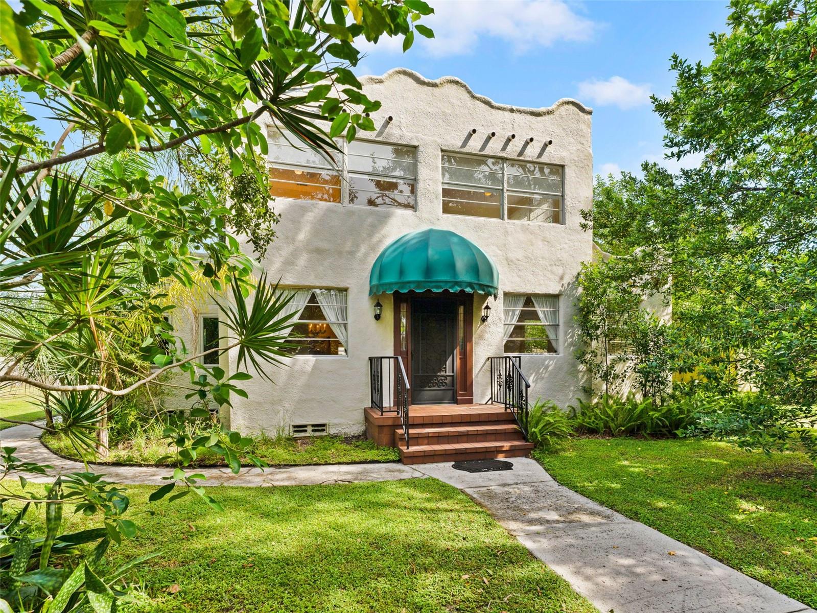 Mulitple offers received. Highest and best by 9/10 at 5pm.....Welcome to your Mediterranean Sanctuary in central St. Petersburg! As you pull onto the quiet, oak-lined street, a feeling of serenity takes hold. Nestled on a manicured quarter-acre double lot, this 1922 Mediterranean-style 3 bedroom, 1.5 bathroom home welcomes you. The charm is immediate, with a gated entryway, arched stoop, and classic stucco façade character and whimsy abound, inside and out.
The original oak floors greet you as you step inside the sun-drenched living room, transitioning seamlessly into the updated oak flooring throughout the kitchen and formal dining space, uniting the home in warmth and continuity. A wood-burning fireplace anchors the living area, flanked by soft archways and glowing natural light. The remodeled kitchen is a masterpiece of craftsmanship. Jatoba hardwood countertops, known for their durability and deep color, pair beautifully with hand-molded Seneca ceramic tile backsplash accented by teak trim. A custom island crafted from mixed tropical hardwoods offers stunning contrast, while a porcelain farmhouse sink, built-in wine and cookbook racks, pull out spice drawers, and an induction cooktop elevate both function and style. The open flow into the dining area creates the perfect setting for both quiet mornings and vibrant gatherings.
Tucked just off the main living space, a completely remodeled sunroom streams light through the Jeldwen Premium Atlantic hurricane windows and offers flexibility for a home office, studio, or cozy den. Upstairs, three bedrooms exude character, with vintage details and room to personalize.
Step outside to a covered deck overlooking the double lot—your private oasis for evening wine or weekend brunch. The detached four-car garage, with over 1,400 square feet, and alley access, opens up endless possibilities: workshop, ADU, artist studio, or storage.
Meticulously maintained with modern upgrades—remodeled kitchen and dining (2017), partially upgraded systems, partially updated hurricane-rated windows, and a 50-year silicone-coated roof—this home blends history with peace of mind.
Centrally located, you’ll be just minutes from downtown St. Petersburg, award-winning Gulf beaches, Tampa International Airport, and local favorites like Trader Joe’s, Mazzaro’s, Whole Foods, and Publix. Tucked on a quiet, oak-lined street with friendly neighbors, this home delivers both convenience and community. Come see this marvelous Mediterranean gem and make it your sanctuary today!