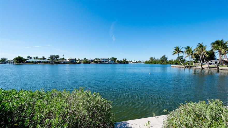 Large lot with expansive views on Bimini Bay. There is 14,680 total square feet with 234 feet on the water.  The lot wraps around the canal for clam waters for your boat and dock.  Easy access to the Intracoastal Waterway and Anna Maria Sound. Quiet, deep water for your boat. Sea wall has been recently repaired. No damage to this property during recent storms. Plenty of room for a pool. Surrounded by multi- million dollar homes. The neighbor hood is changing as new homes are being built. One of the most desirable building lots in Key Royals. The community has a private gulf club and is located minutes to the beaches of Anna Maria Island as well has great restaurants, boutiques and shopping. The current home would need to be removed. See MLS LISTING A4674316.  Come build your dream home and watch sunsets from your own back yard.
