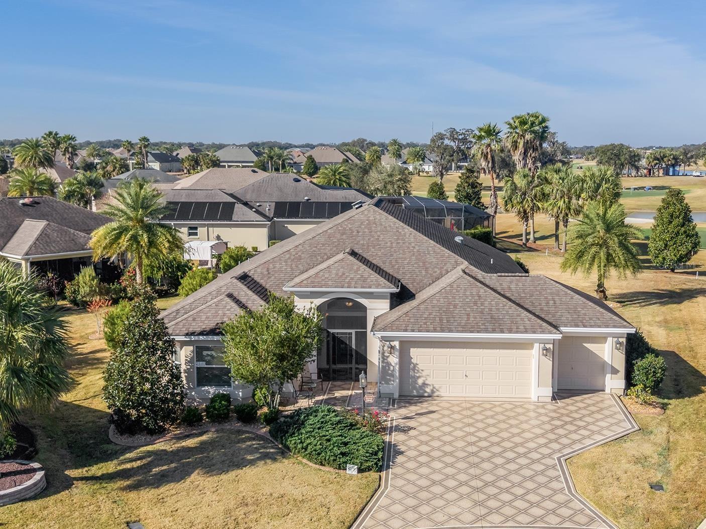 Expansive Ivy floorplan on a one of a kind oversized homesite where you can watch golfers putt on hole six of Evan's Prairie Championship Golf Course with water view. You will have plenty of space for the swimming pool, spa or outdoor area of your dreams. The best part is you have room for all three if you wish. Gourmet kitchen with granite countertops, tile backsplash, gorgeous maple cabinets with pull out shelves and enhanced appliances. Tile floors in the main living area and all wet areas. Spacious primary suite accommodates your king size furnishings and has a walk-in closet. Location is everything and here you are located moments from Pinellas Plaza for grocery, medical and other services. The entry has a painted driveway, paver walkway, screened in front entry. Outside your view through stacked sliding glass doors and enjoy the serenity of your glassed enclosed lanai. The two-car plus golf car garage has durable epoxy floors and comes with storage cabinets and a Pegasus water system. All the furniture and kitchenware items are included making this a convenient turn-key home. The 2024 Yamaha Golf Cart is available separate. Brand new HVAC installed in 2025. Call now - for your own private tour. Your nearest Regional Rec Center is Eisenhower and Brownwood Paddock Square is the closest Town Square with Sumter Landing Square only 12-15 minutes away. Will not last long.