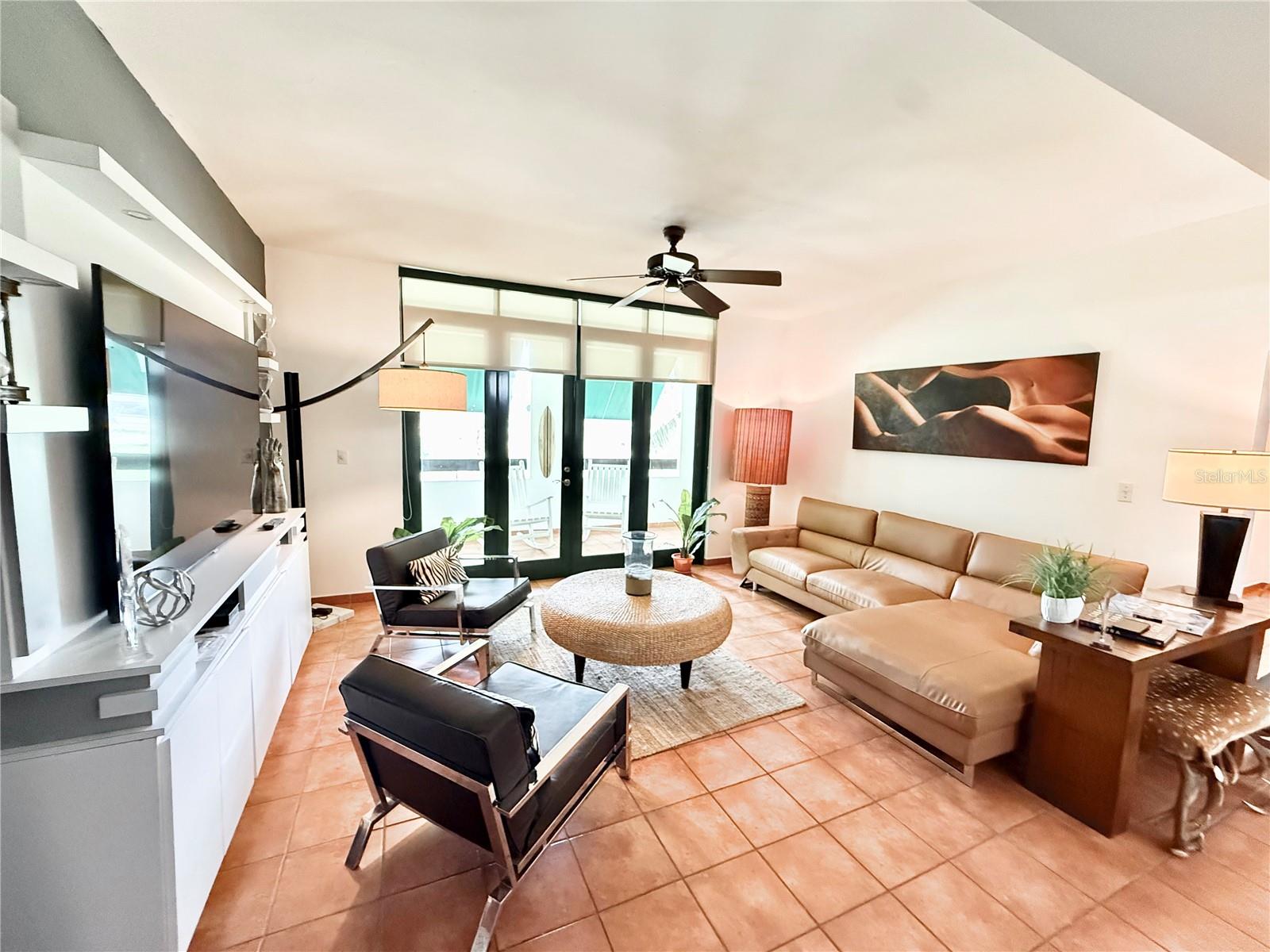 Embrace elevated tropical living in this stunning villa offering panoramic views of the golf course, situated in Rio Mar Village, inside the exclusive Wyndham Grand Rio Mar Puerto Rico Golf & Beach Resort on the island’s east coast. This tastefully furnished 2,226 sq. ft. home features three well-appointed bedrooms, each with its own en-suite bathroom. The primary suite includes a generous walk-in closet and a private bathroom. A stylish powder room adds further convenience. The expansive kitchen connects seamlessly with the open-air terrace, allowing for effortless indoor-outdoor living. The building includes a backup battery, a water cistern, and gated entry for added security. Three assigned parking spaces are also included with the property. As a resident, you'll enjoy the resort's exceptional amenities such as direct beach access, oceanfront pools, a luxurious spa, casino, fully equipped gym, nine dining options, boutique shops, and tennis courts. Golf enthusiasts will appreciate two professionally designed 18-hole golf courses. Located just a short drive from San Juan and the airport, Rio Grande is also home to the lush El Yunque National Rainforest, vibrant local cuisine, and the exciting Carabalà Rainforest Adventure Park.
