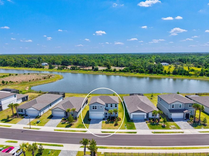 Better than brand new and only 2 years old, this energy-efficient San Marino floor plan by Meritage Homes is available now in the heart of Nokomis, located within a gated community for added privacy and peace of mind. What truly sets this home apart, and is rarely found in today’s market, is the combination of 5 true bedrooms, a spacious loft, and a dedicated flex room / home office, a layout that offers a level of space and flexibility most homes simply cannot match.

Offering 5 bedrooms, 3.5 bathrooms, and a 2-car garage, this thoughtfully designed home features an open-concept layout with a highly desirable first-floor primary suite. As you enter, you’re welcomed by a versatile flex space and private office, leading into a beautifully appointed kitchen with 42-inch upper cabinets, quartz countertops, an under-mount sink, stainless steel appliances, and a corner pantry with custom wood shelving.
The main living areas showcase modern tile flooring, while the primary suite offers plush carpeting, dual vanities, a spacious walk-in shower with seamless glass, and a large walk-in closet. Sliding glass doors open to a covered lanai overlooking a stunning water view with a preserve behind it, creating a private and peaceful setting.

Upstairs, the rare layout continues with a large loft ideal for entertaining or additional living space, along with four spacious bedrooms, and two offering large walk-in closets, and two full bathrooms. Additional highlights include a large main-level laundry room, ample storage throughout, all appliances included, and full hurricane impact windows and doors for added peace of mind.

Even better, this home is NOT located in a flood zone, meaning most lenders will not require flood insurance, a huge long-term savings. Current homeowner’s insurance is approximately $2,200 per year, which is extremely attractive for a home of this size and age.
With an incredibly low HOA of just $150 per year, this home also offers convenient access to I-75 and is just minutes from shopping, dining, and the vibrant downtown areas of Sarasota and Venice. It is also ideally located near some of the area’s top-rated schools including Laurel Nokomis School, Venice High School, and the highly sought-after Gifted Pine View School.

Residents of Magnolia Bay enjoy resort-style amenities including a clubhouse, pool, fitness center, pickleball courts, and more. This is your opportunity to own a like-new home with a floor plan and value that are truly hard to find.