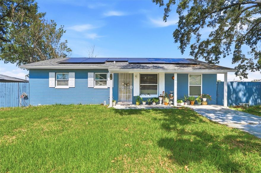 Cozy concrete block home in Kissimmee just minutes from downtown — offering 1,495 sq ft of living space, 3 bedrooms, 2 bathrooms, and no HOA. Sitting on a fully fenced lot shaded by mature oak trees, this home has great bones and a welcoming feel from the moment you pull up. The covered front porch sets a relaxed tone, with plenty of room to sit and enjoy the outdoors. Inside, the open living room features tile flooring throughout and flows into a separate family room area, giving you flexibility for how you use the space. The kitchen offers honey-toned wood cabinetry, stainless steel appliances including refrigerator, range, and microwave, updated LVP flooring, and connects to an additional flex sitting area — ideal as a breakfast nook, office, or second lounge. Out back, a concrete patio opens to a spacious, fully fenced yard with a storage shed and plenty of room to spread out. The home is equipped with solar panels — helping reduce monthly energy costs. Please note solar panels are financed. Conveniently located near US-192, dining, shopping, and all of Central Florida's attractions.