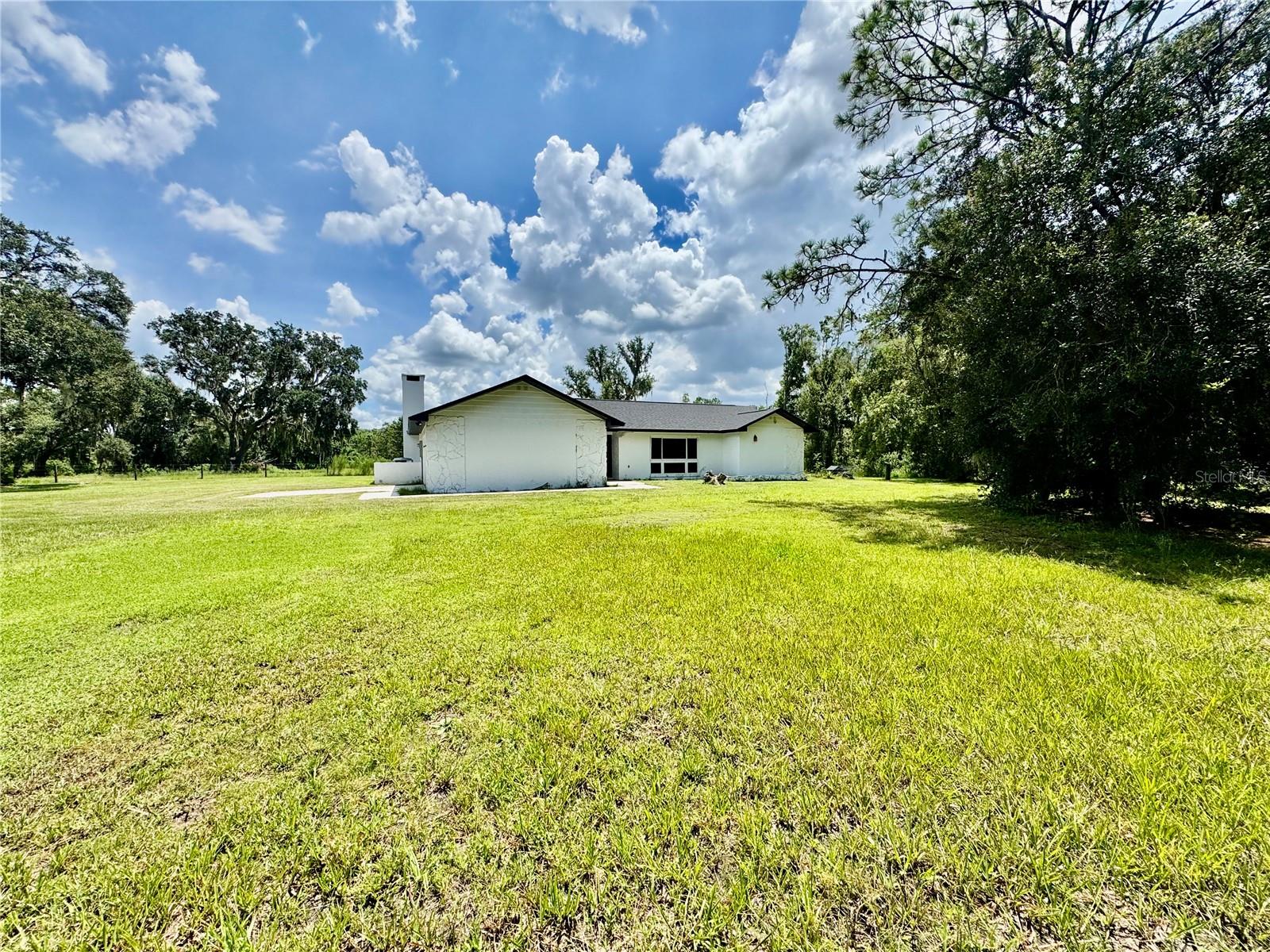 Welcome to your private oasis! Nestled on 2.5 acres in the peaceful northern side of Plant City, this beautifully updated 3-bedroom, 3-bathroom home offers the perfect blend of comfort, privacy, and modern upgrades. Step inside to discover a spacious layout featuring a newer kitchen complete with solid wood cabinetry, granite countertops, and plenty of storage. Each of the three bathrooms has been thoughtfully updated, offering a fresh and stylish feel throughout the home. Major upgrades provide peace of mind, including a new roof (October 2022), updated A/C system and ductwork (2022), and all new windows and doors installed in 2019—ensuring efficiency and long-term value. Whether you're relaxing indoors or enjoying the expansive outdoor space, this property offers the perfect backdrop for quiet country living with modern comforts. Don't miss this rare opportunity for privacy and space just minutes from town amenities. Schedule your private showing today!