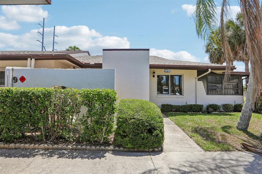 One or more photo(s) has been virtually staged. Beautifully updated corner-unit villa in the highly sought-after New Haven 55+ community in Largo, offering maintenance-free living, peaceful water views, and a true resort-style lifestyle. Designed for comfort, ease, and enjoyment, this move-in ready two-bedroom, one-and-a-half bath home features three exterior porches, including a fully enclosed lanai overlooking a tranquil pond—the perfect place to relax, unwind, and enjoy Florida living year-round.

Inside, a bright and inviting open layout creates a relaxed, easy flow for everyday living. Fresh interior paint and modern finishes enhance the space, while the remodeled kitchen offers soft-close white shaker cabinetry, granite countertops, and a brand-new dishwasher. The open design connects seamlessly to the dining and living areas, making entertaining simple and comfortable. Ceramic tile flooring throughout the main living spaces adds a clean, low-maintenance finish.

The spacious primary suite is a private retreat, featuring new luxury vinyl flooring, sliding glass doors leading directly to the lanai with peaceful water views, a walk-in closet, ceiling fan, and an updated en-suite half bath with new vanity. The guest bedroom offers the same comfort with new luxury vinyl flooring and ceiling fan, while the second bathroom has been tastefully updated with a new vanity and glass-enclosed shower.

Important updates provide peace of mind, including a new roof (2024), updated gutters and doors (2024), impact-rated front entry door with side light, storm shutters being installed, and a new water heater installed in 2023. Additional conveniences include an indoor laundry room, assigned covered parking, and ample storage—supporting an easy, low-stress lifestyle.

Residents of New Haven enjoy a vibrant and social 55+ community with access to a heated pool, jacuzzi, clubhouse, fitness center, and tennis courts. The HOA delivers exceptional value by covering cable, internet, water, trash, flood insurance, exterior maintenance, and more—allowing for truly worry-free living.

Ideally located near shopping, dining, golf courses, parks, and Florida’s Gulf beaches including Indian Rocks Beach and Clearwater Beach, as well as both St. Pete–Clearwater and Tampa International Airports.

Enjoy the comfort of a beautifully maintained waterfront home in a community designed for connection, relaxation, and effortless Florida living.