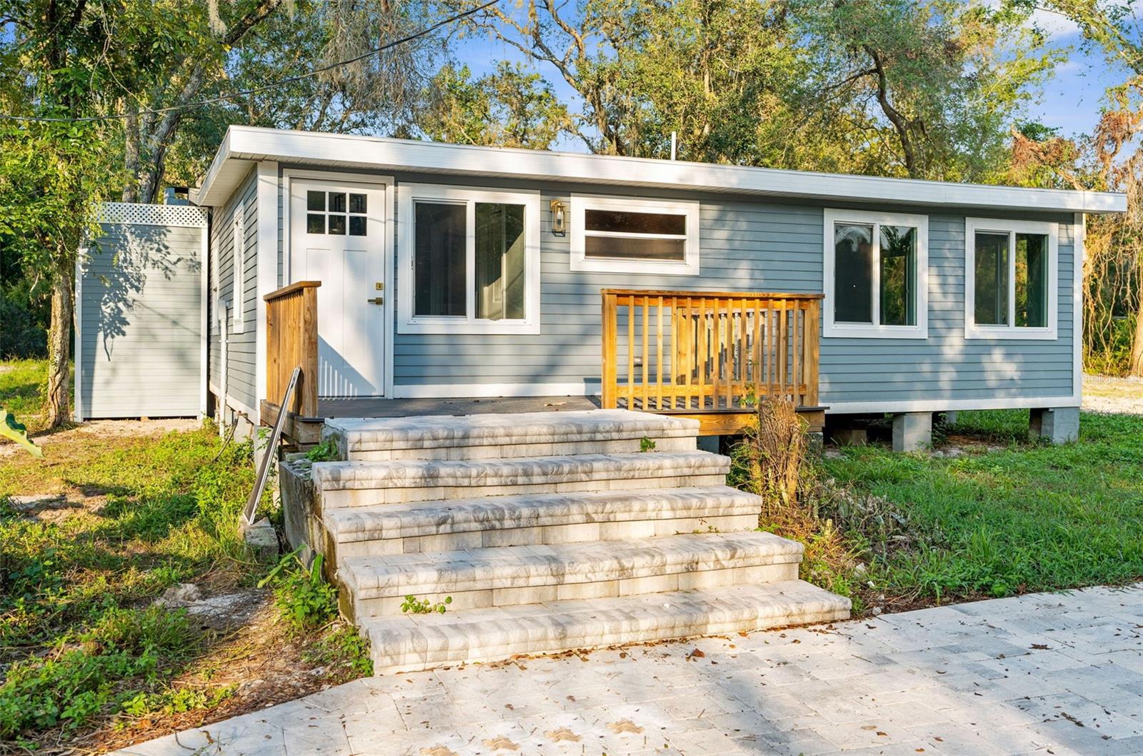 Dreaming of living in the country on the river?? Come see this remodeled 3/2 custom cabin on a double lot on the Withlacoochee River!! 3.74 acres on beautiful land and trees with over 200 feet of river frontage!!! ** This home did NOT flood with the hurricanes on 2024!! ** The home and property can be used as a short-term vacation rental for an income producing property!! NO HOA!! Bring your kayaks, boats, fishing poles...bring it all!! This home has been completely remodeled from top to bottom!! Everything is NEW!!! Gorgeous siding! NEW ROOF. NEW WINDOWS. NEW FLOORING. NEW KITCHEN. NEW BATHROOMS. Come see it! Beautiful glass sliders to overlook nature!! Luxury Vinyl Flooring throughout! Kitchen is upgraded with new white kitchen cabinets, waterfall island with granite countertops, waterfall sides, and backsplash!! New Stainless Steel Appliances!! Bathrooms are gorgeous with NEW stunning shower walls, cabinets, Quartz countertops, and backlit mirrors! Come feel the peach and serenity that nature and the river brings you!! 3.74 acres MOL. Double Lot. 379 feet of road frontage. Lots are 585 feet deep. 200 feet of river frontage!! Large piece of property to give you space from neighbors!
