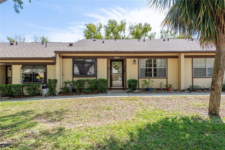 On the market, first time in 20 years! Step into this gorgeous 2-bedroom, 2-bath condo, situated overlooking green space area in the scenic Dollar Lake Village within the highly desirable Timber Oaks 55+ community. This lot is located on one of the highest points in community.  No flooding or damage during last hurricane season or seller says in the entire 20 years she has owned it.  New Roof within last 2 years. This move-in-ready unit blends comfort with style, offering a bright and welcoming atmosphere. A stylish glass storm/screen door invites you inside, leading to a modern kitchen equipped with white appliances, a reverse osmosis system, a closet pantry, and open to dining and great room. The spacious dining and living areas are bathed in natural light from a solar tube, there’s also a flexible space perfect for a dry bar, coffee station, or additional storage.
The home features beautiful bamboo wood flooring throughout the common areas, while the bedrooms are cozy with plush carpeting. Triple sliding glass doors open to a large, hardwood flooring in Florida Room with vented A/C, a versatile space that includes a convenient storage. Laundry room. Washer and Dryer included.  Whirlpool Dryer (2017). Enjoy your morning coffee in the private enclosed back porch, where you can relax with a view of green space.

The split floor plan offers plenty of privacy, making it ideal for hosting guests or setting up a home office. The generously sized primary bedroom opens through double sliding glass doors into the Florida Room and boasts an en-suite bath with a make-up area, walk-in closet, and shower. Additional features include A/C (2014), a covered carport, and a storage closet. 

Monthly condo fees cover reserves, cable, internet, water, sewer, trash, roof, and exterior maintenance. Residents also enjoy access to Dollar Village’s private unheated pool, as well as Timber Oaks' clubhouse, which offers a fitness room, heated pool, pickleball and tennis courts, a card room, a pool table, and numerous social events and clubs. Come experience the comfortable, convenient, and active lifestyle that Dollar Lake Village and Timber Oaks —your ideal 55+ community awaits!