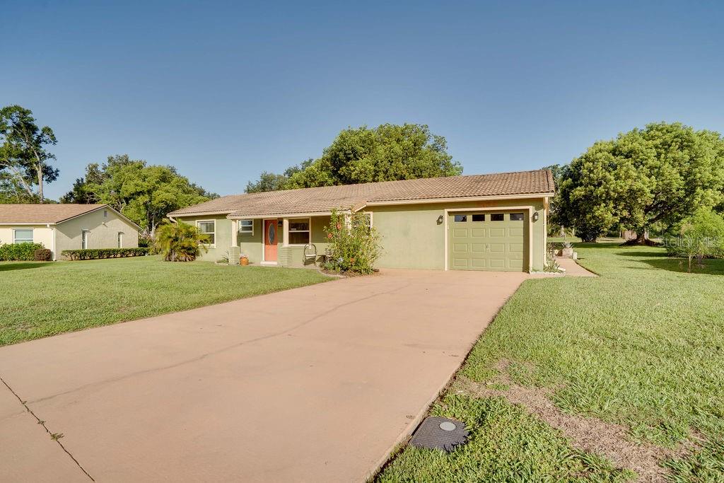 Welcome to this well-maintained 2-bedroom, 2-bathroom home situated on a spacious nearly half-acre lot in the desirable Lake Dorothea community. Inside, you’ll find generously sized rooms, an open-concept kitchen, dining, and living area perfect for entertaining, and a bright Florida room/sun porch ideal for relaxing year-round. The primary suite features an attached bath with a beautifully tiled shower. Outdoors, the level lot provides ample space for gardening, recreation, or simply enjoying the Florida sunshine. Located on a quiet street with well-spaced homes and larger lots, the setting offers both privacy and charm. A large garage includes a workshop and laundry area, ideal for hobbyists or extra storage. Offered fully furnished or unfurnished—your choice—this move-in ready home is your gateway to peaceful living in a truly lovely community.