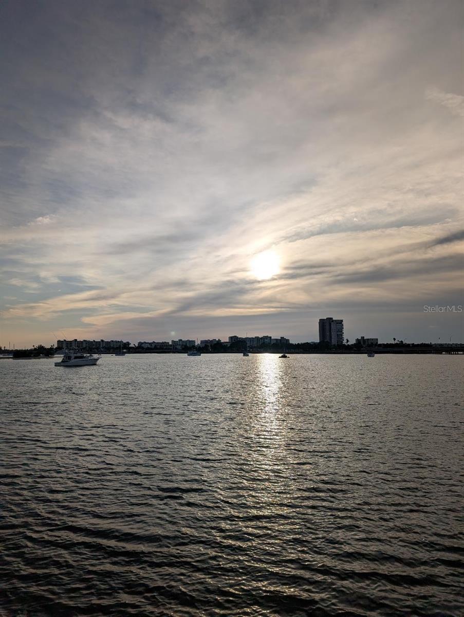 AMAZING VIEWS!! Enjoy breathtaking water and sunset views from 3rd floor of this beautifully 2 bedrooms, 2 bath, plus heated & cooled Florida room (tax records do not reflect Florida room square footage) Enjoy the beautiful open water view from your Florida room overlooking the waters of Boca Ciega Bay and within 1.5 mile to beautiful St. Pete Beaches. This condo has been well maintained, updated kitchen, flooring, baths, A/C. Gas for cooking and heating. Laundry room is just steps away, also a locked storge room on floor. Shore Manor is a well-maintained, resort-style 55+ community. Enjoy relaxing and watching the dolphins and manatees in the bay, or swim in the heated waterfront pool, fish from the dock enjoy a game of shuffleboard or meet with friends at the clubhouse. There is a waterside patio with BBQ grills, picnic tables. Convenient location near bus/trolley stops, restaurants, shops, medical facility & sandy beaches. HOA includes everything except electric.