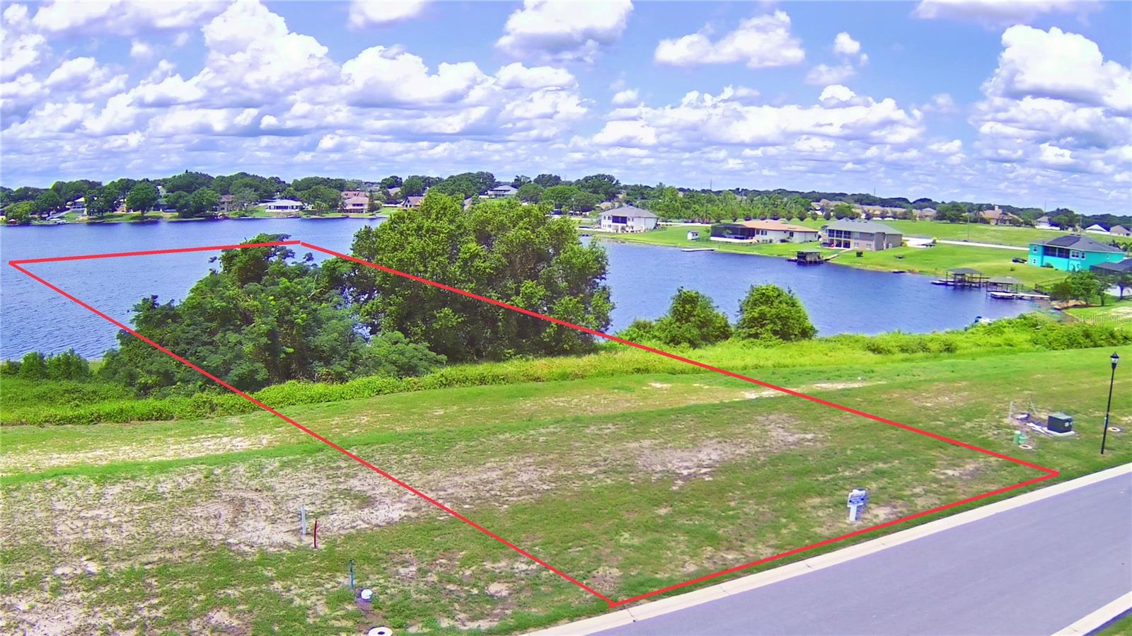Incredible opportunity to own this buildable lakefront lot in gated Lake Juliana Estates! This lot is cleared and ready for you to build your dream home in this community nestled between Lake Juliana and Tennessee Lake with clubhouse/community pool, tennis, basketball, playground, fitness center and dock on Lake Juliana. Don't miss out on your chance to have this lakefront lot to build your dream home on