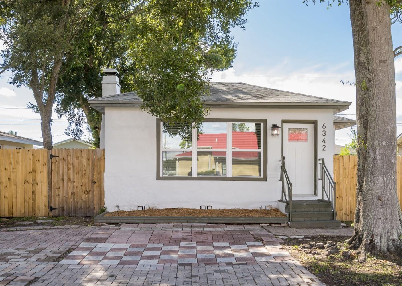 Now on the Market!! Charming Bungalow Style home-- this 2 bedroom, 1 bath blends vintage character with a clean, classic appeal. It has been modernly updated with a brand new roof and privacy fencing, great for pets and backyard entertaining! The kitchen has been newly renovated with new shaker style cabinets and black matte hardware, slow close drawers, solid stone quartzite countertops and a new stainless appliance package to include a French door bottom freezer fridge, new range with the upgraded convection fryer oven feature, a matching microwave range hood and dishwasher. The bathroom has marble tile floors, subway tiled shower to the ceiling and a deep tub to enjoy! This home has a spacious, open floor plan-- the new light laminate flooring laid throughout creates a nice seamless overall flow. The beautiful living room and dining room windows are large, letting such quality natural light in, easily brightening the entire home. There is an enclosed, screened-in porch off of the kitchen that lets so much natural breeze in too, great for just relaxing in and enjoying our Florida evening weather! Located in Pinellas Park close to the 66th St N artery that leads north to the main Park Blvd corridor going east to I-275 leading to the rest of Tampa Bay or west to our gorgeous local beaches!! This home is not in a flood zone and will not require flood insurance.