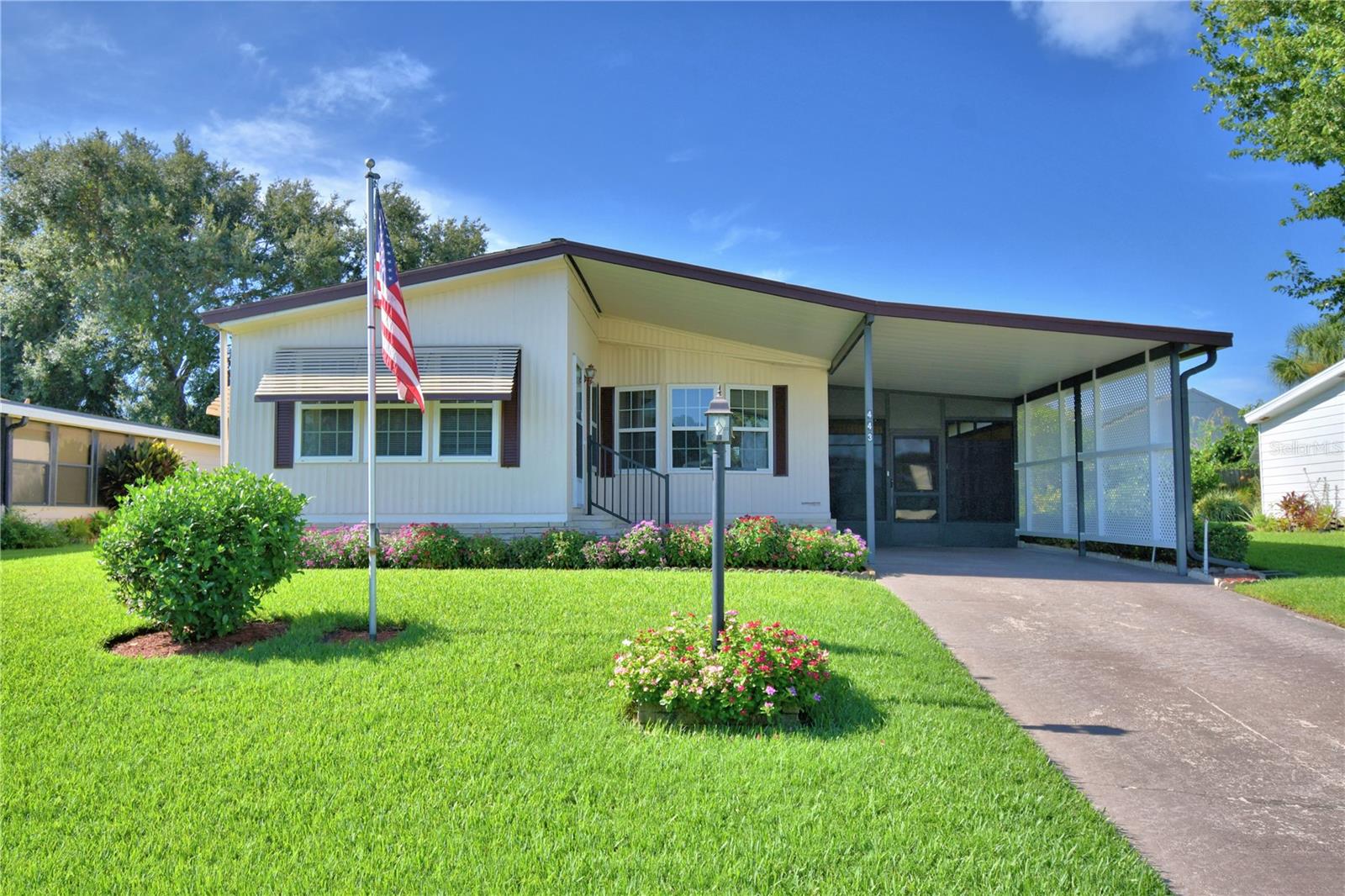 Pride in ownership shines throughout this charming 2-bedroom, 2-bath home in the beautifully maintained and friendly 55+ Village Park community. The lush lawn and meticulous landscaping are kept vibrant with a dedicated irrigation well. Inside, the updated kitchen features stainless steel appliances, granite countertops, stylish backsplash, solid wood cabinets, and a cozy breakfast nook framed by a large window that fills the space with natural light. A separate dining room offers plenty of room for entertaining. The spacious owner’s suite includes an en suite bath with a walk-in shower, while the guest bedroom and nearby second full bath provide a welcoming retreat for visitors. Key updates add peace of mind, including updated plumbing (2019), new tie downs and a replaced moisture barrier (2020), a new AC system (2022), and a water heater (2019). Residents enjoy a clubhouse, shuffleboard courts, and a sparkling pool, plus optional boat, RV, and trailer parking available through the HOA on a first-come, first-served basis for an additional fee. Schedule a showing and don’t miss out on the opportunity to live in this beautiful, 55+ community with fantastic amenities and a welcoming lifestyle.