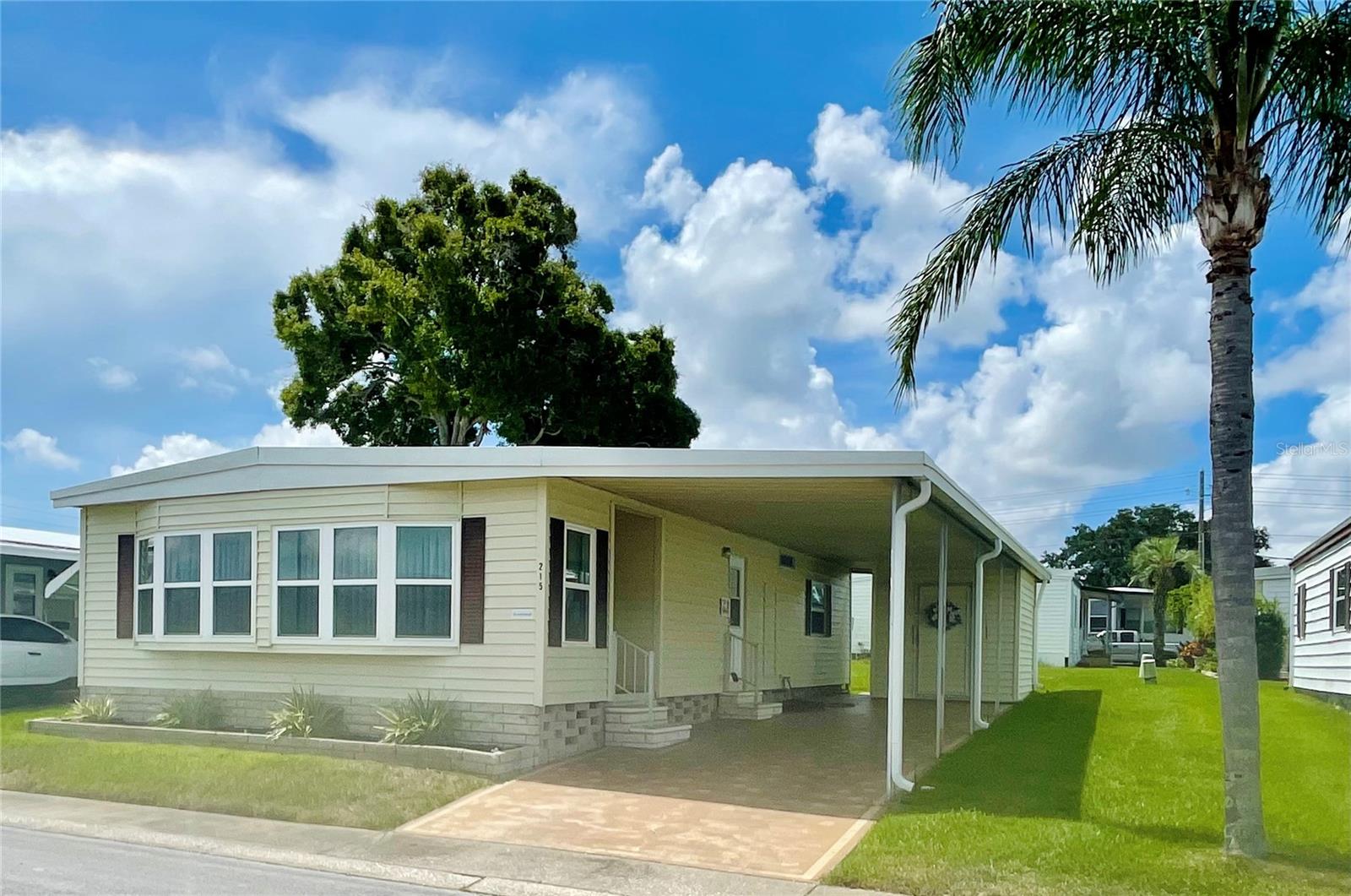 This fabulous two bedroom/two bathroom double wide manufactured home is truly move-in ready and located in a friendly and active 55+ community where you own the land! Step inside to find a light and airy open floor plan featuring upscale finishes throughout. The living room and dining areas are bright and inviting, ideal for relaxing or entertaining guests. The gorgeous kitchen boasts updated white cabinets with soft close doors and drawers, quartz countertops, and stainless-steel appliances. Completely updated bathrooms with new vanities, fixtures, and lighting. Beautiful interior featuring fresh paint. Newer Berber carpets in living areas and luxury vinyl in kitchen and bathrooms. Exterior features include a two-car covered carport, three exterior doors for easy access, and attractive landscaping/curb appeal. Roof 2020. AC 2022. All this at Blue Jay Estates PLUS a low monthly fee of $230 a month includes escrow reserves, water, sewer, trash, lawn care, and more! Non-flood zone!
Blue Jay has a very active social club, lots of activities, a heated pool for year-round enjoyment, shuffleboard and Bocce courts. There is a designated area where you can park your boat or R/V at no additional fee if space is available when requested. Near beaches, the Pinellas trail, parks, shopping, medical centers, and airports.