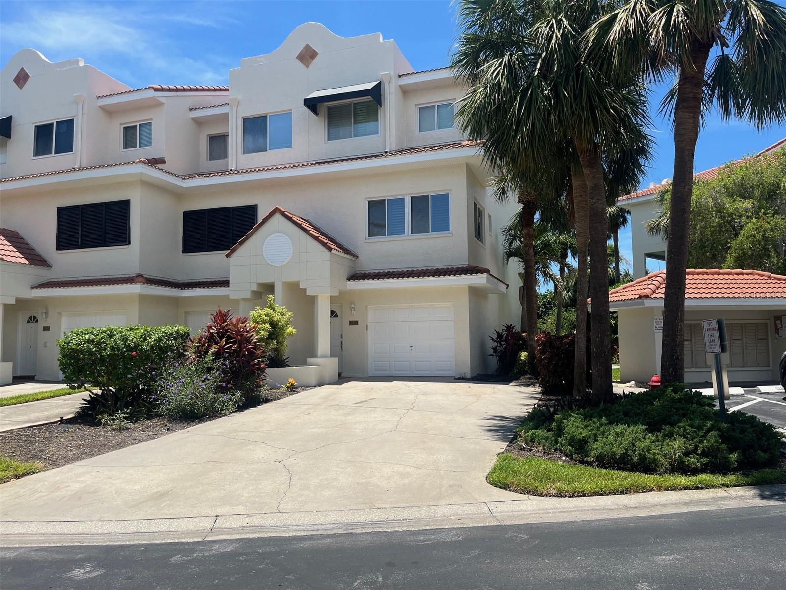 Discover your dream home in this meticulously updated end-unit townhouse, perfectly positioned just a block from the beach. This property offers the coveted advantage of extra light, thanks to its prime location and vibrant, modern finishes. The heart of the home, the kitchen, and all baths have been thoughtfully upgraded with gleaming granite counters and premium solid wood cabinetry. Prepare to be wowed by the master bath's expansive 10' x 10' shower, complete with multiple shower heads for a truly luxurious experience. Beyond the aesthetics, you'll appreciate the durability and style of solid wood shutters on every window. A flexible bonus room on the bottom floor provides endless possibilities, while the double-car driveway ensures ample parking. Step outside to enjoy direct views of the inviting pool, making every day feel like a vacation.