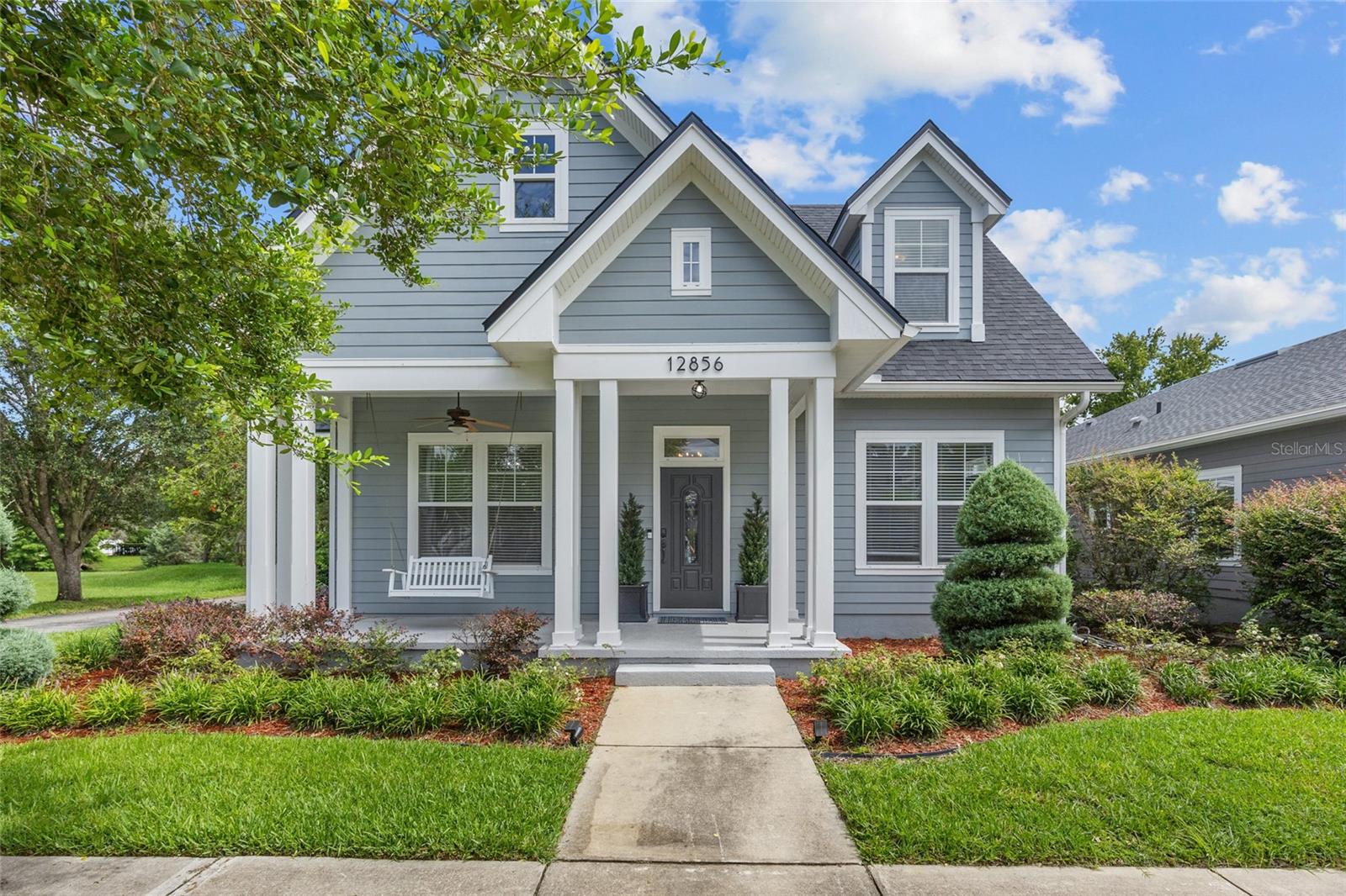 Charming Town of Tioga Home on a Premier Corner Lot! Step into this Pridgen-built residence, perfectly situated on a coveted corner lot next to a tranquil retention area—offering added privacy and open green views. Located in the vibrant and golf-cart-friendly Town of Tioga, this home blends timeless style with modern comfort. With a versatile layout offering 5 bedrooms and 3 full baths—or 4 bedrooms plus a dedicated home office—this property is designed to adapt to your lifestyle. From the inviting foyer, you'll find a formal dining room that sets the stage for memorable gatherings. The open-concept kitchen, featuring an oversized pantry and casual dining space, flows effortlessly into the spacious family room, creating a warm and welcoming hub for daily living and entertaining. The primary suite is quietly positioned at the rear of the home and serves as a true retreat, complete with a generous walk-in closet and spa-like ensuite bath. Two additional bedrooms and a full bath are located on the main level—one currently styled as a functional office. Upstairs, two oversized bedrooms share a third full bath, ideal for guests or family members. Thoughtful upgrades include granite counters, rich wood flooring in some living areas, durable tile in the kitchen and family room, and custom built-ins that add character and function. Enjoy year-round outdoor living with a charming front porch and porch swing, along with a spacious enclosed rear patio—perfect for an additional living area, fitness space, or reading nook. This convenient location is just moments from Tioga Town Center’s restaurants, boutiques, fitness studios, and community events, and less than five miles from I-75 for easy access to Gainesville and nearby cities. Offering the perfect blend of sophistication, flexibility, and location, this exceptional home is ready to welcome its next owners.