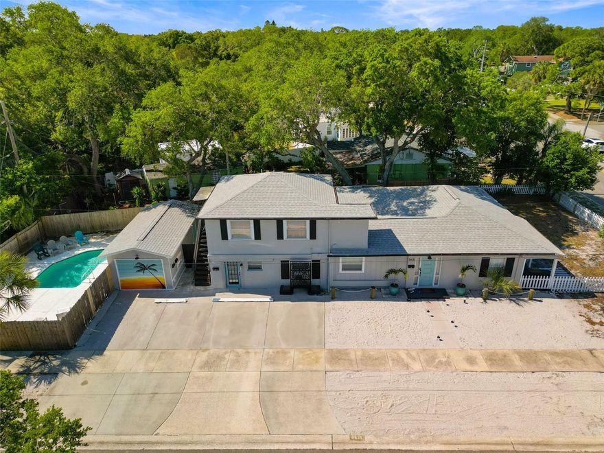 Exciting opportunity to own an updated and modern triplex located in the highly sought-after Jungle Terrace neighborhood of St. Petersburg!  This income-producing property offers excellent cash flow potential, featuring an inviting in-ground pool and a one-car garage, all in a desirable high-and-dry location with no flood insurance required. Unit A, the main house, features 3 spacious bedrooms and 2 updated full bathrooms, with a newly renovated kitchen and modern wood-look flooring. Residents enjoy a private front porch and fenced yard as well as in-unit laundry add to the convenience. Unit B, located on the ground floor, offers 1 bedroom and 1 full and one half bathroom, with a modern kitchen and wood-look laminate flooring and in-unit laundry. Unit C, located upstairs, presents a spacious 1 bedroom, 1 bathroom apartment with a large open living space, modern kitchen, and a big walk-in closet. This unit has a recently renovated bathroom and in-unit laundry to complete the package. Secluded by a wood privacy fence, the pool area offers a spacious deck perfect for sunbathing and is shared by all tenants, creating a delightful communal space to relax and enjoy the Florida lifestyle. Additional features include a New Roof 2023, Central AC Unit A 2017. Each unit comes equipped with its own washer/dryer. Situated in an excellent St. Pete location, just a short drive to Madeira and Treasure Island Beaches, Tyrone Mall area shops, and downtown St. Petersburg’s nightlife and culture is just a quick 15-minute drive away! This is a unique opportunity to own a well-maintained, easy to rent, cash flow positive investment property in a sought-after St. Pete neighborhood! Main house and upstairs tenant are on month-to-month leases, offering flexibility for an owner-occupant buyer. Don't miss this rare opportunity to acquire a cash-flow-positive investment property with a pool in a highly desirable St. Petersburg location.