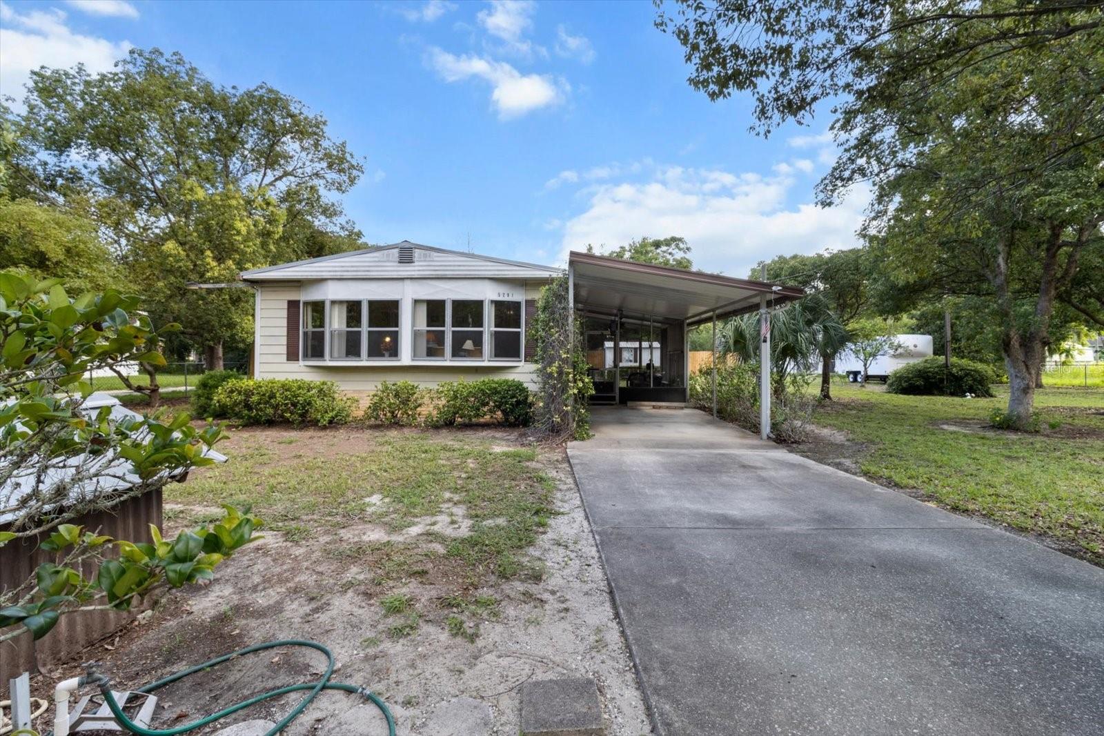CASH ONLY due to age!! Nestled on a spacious 0.39-acre double lot in the desirable Circle M Ranchettes community, this 2-bedroom, 2-bathroom 1980 mobile home offers 1,058 sq ft of living space and is ready for its next owner. Notable features include an HVAC system updated in 2017, upgraded PVC plumbing, updated electrical, a durable metal roof with gutters and leaf guards, and an additional septic tank for an RV: both septic tanks have been recently pumped. The property is fully fenced and includes a paved driveway, a carport, two large sheds, concrete skirting, and a screened porch. It’s serviced by a private water company (no well), has NO HOA, is NOT in a flood zone, and sits on a county-maintained paved road. This home is perfect for full-time living, investors, snowbirds, or anyone looking for a weekend getaway. While it may need some cosmetic updating, it has good bones and is move-in ready! Conveniently located near shopping, dining, and popular outdoor activities like boating and bass fishing on Lake Rousseau, tubing down the Rainbow River, and kayaking the Withlacoochee River. Don’t miss out on this great opportunity & schedule your showing today!