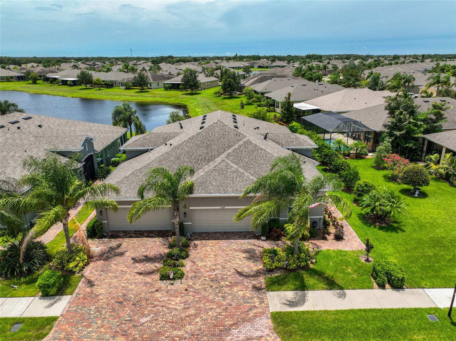 CONTEMPORARY COASTAL and ELEGANT is the best way to describe this MAINTENANCE FREE, SPARKLING CLEAN, WATER VIEW Villa located in the desirable GATED community of Renaissance known as Verona. And it is ONLY 100' from the PRIVATE VERONA POOL RESORT. *A very popular OPEN FLOOR PLAN model, the “Mahogany”, is a 2 bed/2bath home WITH A DEN/OFFICE. It is 4.5 years YOUNG and is than new. This home has all of the touches of a PROFESSIONAL DECORATOR. *The EXPANSIVE KITCHEN includes such HIGH-END FEATURES as GRANITE COUNTERTOPS, STAINLESS STEEL APPLIANCES (including a DOUBLE OVEN), 42” HONEY TONE, ALL WOOD cabinets. *Large, beautiful, LOW E-ENERGY EFFICIENT windows, with PLANTATION SHUTTERS, allow the Floridian sunshine to naturally filter throughout the home. CONTEMPORARY PAINT TONES accent the walls and TREY CEILINGS, which make the CROWN MOLDING pop. The light fixtures are MODERN. *The LARGE OWNERS SUITE is relaxing and CALM with COASTAL tones being carried on through the master bathroom. There is a LARGE, WALK-IN, CALIFORNIA STYLE closet for ultimate storage and ORGANIZATION. The en-suite bath boasts of GRANITE COUNTERS, DUAL SINKS, PRIVATE water closet and lovely walk-in shower. All of the bedrooms are spacious with OVERSIZED windows for maximum enjoyment of the views. *The dining room, while separate is still open to the main floor plan for easy entertaining. *The den/office is comfortable and the only room with carpeting specific for reduced noise. *The LANAI provides the perfect space for grilling, reading or entertaining, while overlooking the water and the wildlife. *The garage has a lovely EPOXY FLOORING and the CUSTOM PAVER-STONE driveway and walkway, adds such a rich feel to the entrance. *One of the best features about this home is that ALL EXTERIOR MAINTENANCE is taken care of by the HOA association. Nothing for you to do but enjoy all that this active community offers. The unique gated community of Verona offers its own private, resort-style amenities and all the pleasures of a hall of fame maintenance free retirement community. Come and enjoy the world-class country club, fine dining, 5 resort style pools, two state-of the-art fitness centers, spa, saunas, hundreds of social and sports clubs and more. Start living the dream!! Sun City Center has 3 beautiful clubhouses, dance, theater, an arts and crafts building, state-of-the-art medical facilities, shopping, endless entertainment & resources all accessible by golf cart. Verona in Sun City Center is a great place to live! Come and see why this is the place to retire, according to the New York Times and have fun, especially with this home. NOTE: Most of the furniture is available for sale under separate bill of sale. Roof 2019; A/C (on continuous service contract) 2019; Water Heater 2023; Water Softener 2021
