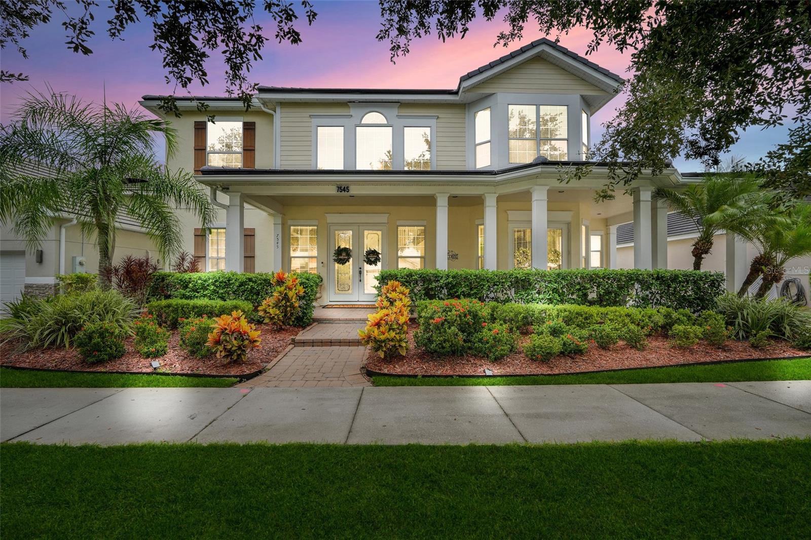 Welcome to 7545 Lake Albert Drive. Where timeless architecture meets modern luxury. Nestled on an expansive lot in one of Windermere's most sought after communities, this stunning estate offers the perfect balance of privacy, comfort, and resort-style living just minutes from Walt Disney World and the best of Central Florida.
Arrive via a long, elegant driveway, framed by lush landscaping, leading to a spacious rear detached garage connected by a breezeway. This meticulously maintained estate features a NEW ROOF, ensuring both peace of mind and long-term value.
Step inside and be greeted by an oversized foyer and soaring ceilings, filling the home with natural light throughout. A wooden staircase with wrought iron accents adds a touch of elegance, while the open layout seamlessly connects living, dining, and entertaining spaces.
The gourmet gas kitchen is a chef's dream, featuring granite countertops, custom solid wood cabinetry with crown molding, a center island, and upgraded finishes. A convenient powder room on the main level ensures effortless entertaining.
The primary suite, located on the first floor, is a private retreat with direct pool access. The spa-like primary bath includes a walk-in shower, soaking tub, and dual vanities.
Upstairs, you'll find three additional bedrooms and two full bathrooms including a private en suite, plus a catwalk overlooking both living spaces below.
Outdoor living is a true highlight with multiple covered spaces, including a front porch and screened in pool. The poolside exterior bathroom adds convenience for seamless indoor-outdoor living. The summer kitchen is perfect for entertaining with a built-in gas grill, sink, refrigerator, and storage, plus a breezeway patio and fire pit area. Permanent Govee lighting sets the mood for unforgettable evenings spent under the stars.
The community features Lake Burden pier for fishing, beautifully maintained parks, playground, and tennis courts for active living and recreation.
This home delivers the full Florida lifestyle whether you're hosting poolside gatherings, unwinding in the private backyard, enjoying community amenities at Lake Burden and the tennis courts, exploring Windermere's lakes and boutique shops, or experiencing world-class attractions like Walt Disney World just minutes away.
