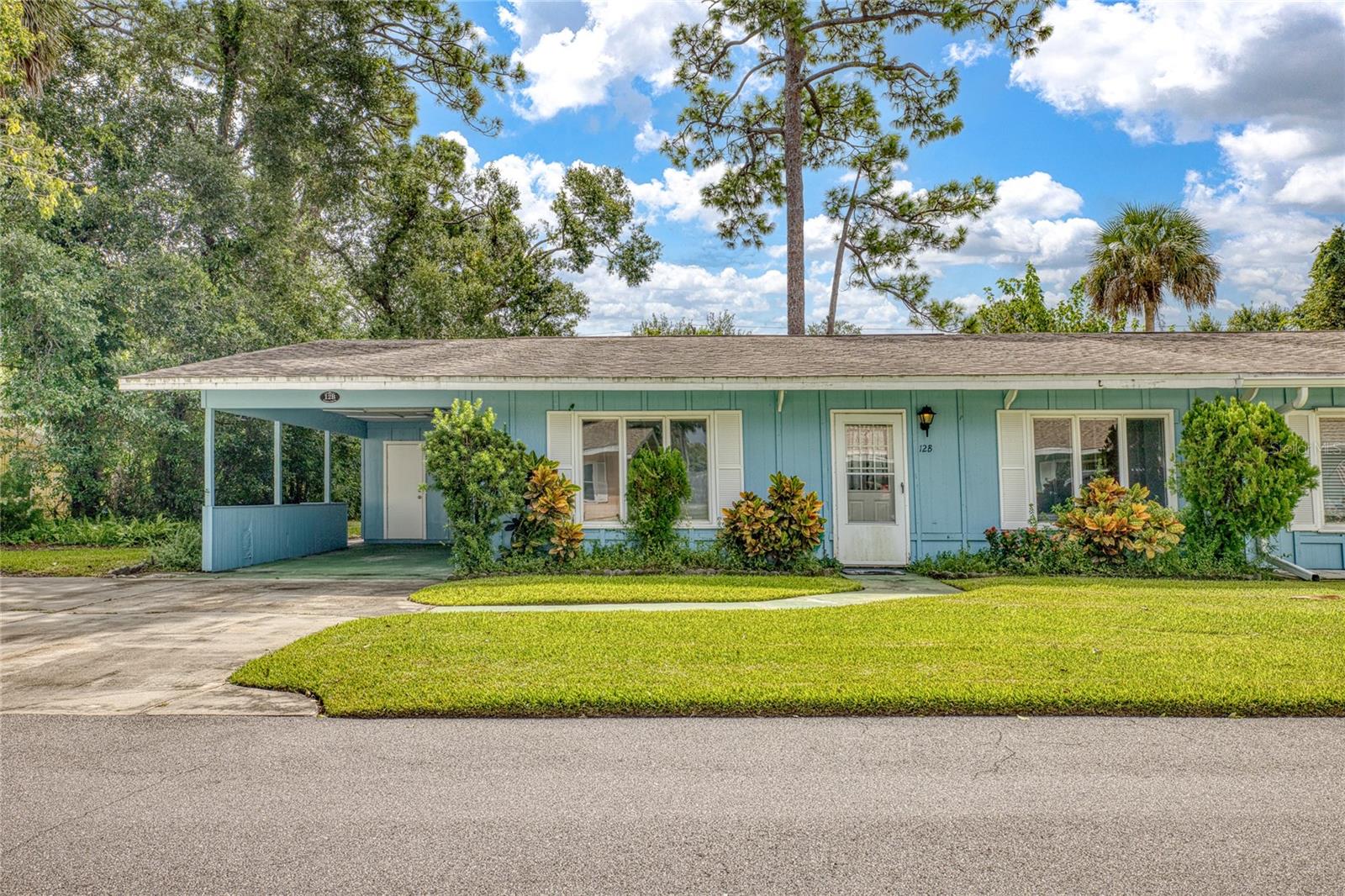 Welcome to this well-situated half duplex in the heart of beautiful New Smyrna Beach! Conveniently located near the golf course, shopping, and everyday necessities, this home combines comfort and lifestyle. Inside, you'll find spacious living areas with high ceilings, three bedrooms and two full bathrooms, plus a carport and paver back patio. The highlight is the large open kitchen with a center island, dining area, and breakfast nook, featuring beautiful wood floors that add warmth and charm. In 2012 the kitchen was updated with new cabinets and counters and the two bathrooms were remodeled with new tile and a walk-in tub was added to the primary bathroom. This lovely home has a lot of potential and is waiting for you to put your personal touch on it. As a part of this active and welcoming 55+ community, residents enjoy access to a clubhouse, pool, putting green and an active neighborhood.