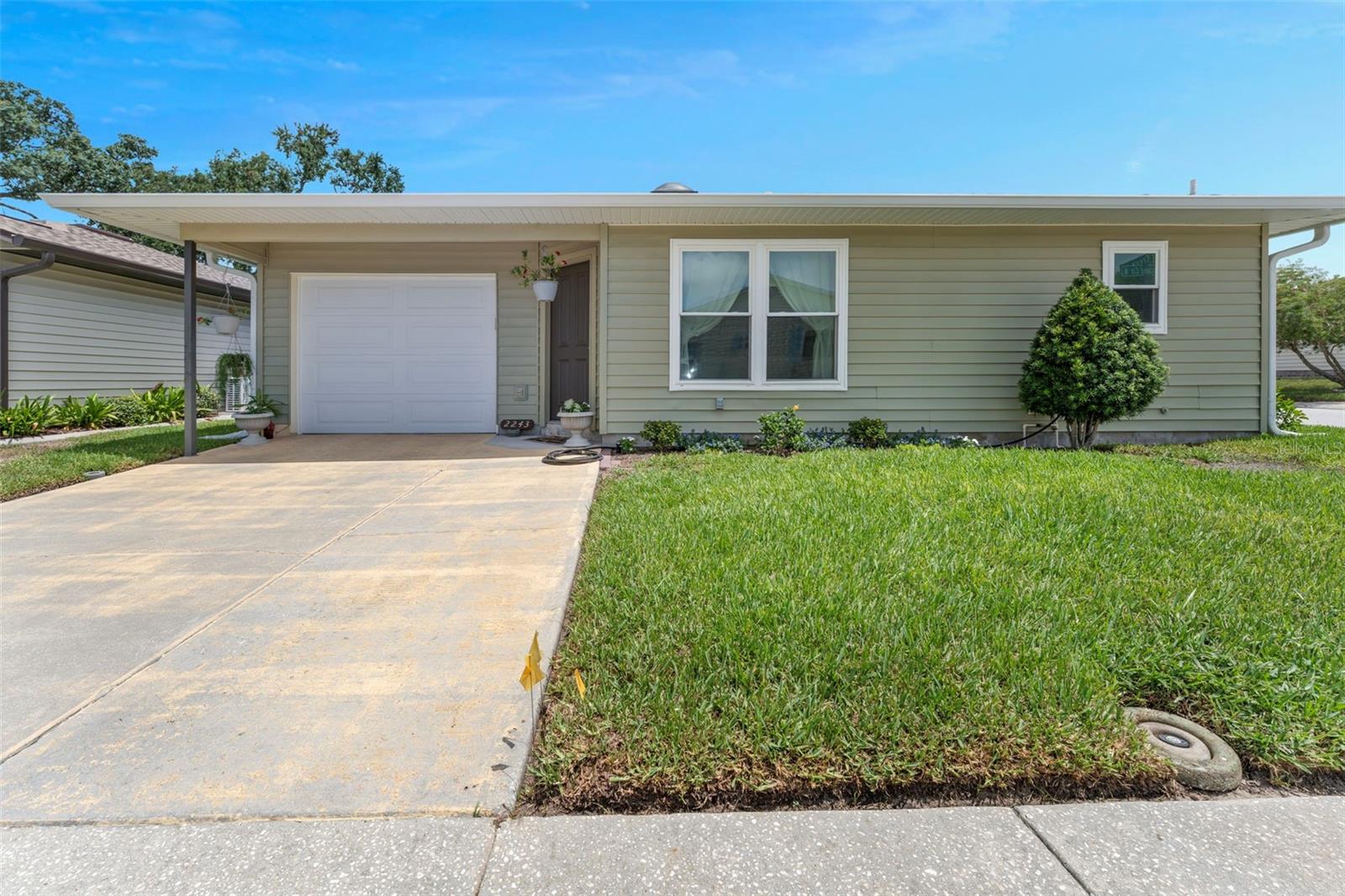 Quaint 2 bedroom 2 bath home in the very desirable mid-Florida golf retirement community of Highland Fairways. Many upgrades and changes have already started and you'll have a blank slate to improve upon. The kitchen features newer appliances and nice wood looking floors. You will enjoy entertaining or just resting in the screened in room off the kitchen. Newer garage door, windows, roof and air conditioner gets you well under way to having your own little piece of paradise. Having a garage as well as living on the corner is a bonus. Make sure you put this on your 'have to see' list - you'll like what you see.