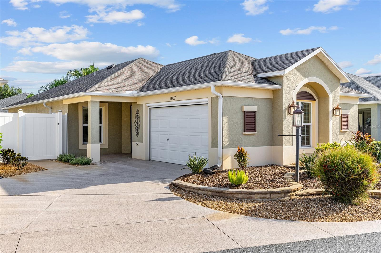 Village of Pine Ridge – Reagan Villas!! Meticulously Maintained Cambridge Courtyard Villa LOADED WITH UPGRADES in a Prime Location in The Villages, FL! -- Built in 2015, this Concrete Block and Stucco Villa features 1,270 sq ft of living space with 2 bedrooms, 2 baths, High and Vaulted Ceilings, and NO CARPET. -- You'll find COREtec 100% Waterproof Luxury Vinyl Plank Flooring in the Main Living Areas, paired with CROWN MOLDING, CUSTOM WOOD CORNICES, and THREE SOLAR TUBES that brighten the space with Natural Light. The Driveway, Walkway, and Front Porch are CUSTOM PAINTED, and the Garage includes a HIDEAWAY SCREEN, Insulated Garage Door, Radiant Barrier Attic Insulation, Attic fan, Built-in Workspace, and Rock Mulch in the Mature Landscaped Beds. -- The Kitchen boasts Recessed Panel Hickory Cabinets with Pot Drawers and Pull-outs, a Breakfast Bar Overhang, and a Reverse Osmosis System. The OPEN LAYOUT offers Spacious Living and Dining areas, with TV Mounts and In-wall Wiring Ready for your Setup. The Guest Suite features a BUILT-IN QUEEN MURPHY BED, Closet, and an EN-SUITE BATHROOM with a Tub/Shower combo, while the OWNER'S SUITE showcases a TRAY CEILING, EN-SUITE BATH with Pocket Door Entry, Walk-in Closet, Dual Sinks, a Tiled Step-in Shower with Glass Door and Bench Seat, and a Linen Closet. -- Relax in the ENCLOSED FLORIDA ROOM with ROLL-DOWN SHADES, Recessed Lighting, Ceiling Fan, and 12-foot Glass Slider Doors (with a Six-foot Opening) leading to the Rear Courtyard. -- Outdoors, you’ll enjoy CUSTOM-PAINTED Rear and Side Patios surrounded by Professional Landscaping. -- The Grage is outfitted with a TILED VINYL FLOOR, HVAC Closet, Washer and Dryer (2021), BUILT-IN WORKSTATION, Extra Wall-mounted Cabinets and Wire Shelving, Utility sink, Pull-down Attic Stairs, and HIDEAWAY SCREEN. -- Ideally located just 0.5 miles from the Escambia & Okeechobee Executive Courses and Moyer Recreation Center & Family Pool, 0.8 miles from Pine Ridge Pool & Mail Station, 2.5 miles from Belle Glade Country Club, and only 1 mile from Colony Plaza Shopping Center and MORE —this move-in ready villa offers incredible convenience. You don’t even need a car. -- Please enjoy the attached VIDEO WALKTHROUGH and DRONE FOOTAGE and Schedule your Private Showing TODAY!