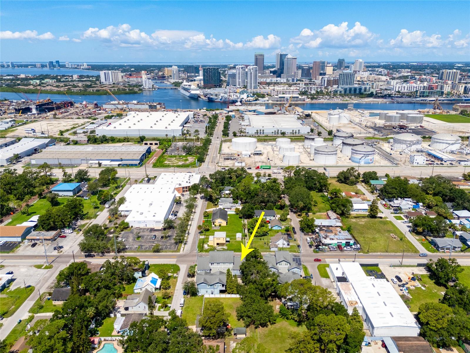 This townhome in Palmetto Beach is just minutes from Downtown Tampa, Channelside, Sparkman Wharf and Ybor City, you could live right near the action while offering the comfort and privacy of a quiet, tree-shaded community. Located in the East Channelside Townhome Community, you'll be welcomed by stylish architecture, pavered common areas, and mature oak trees that provide a cool, inviting atmosphere. Inside, the home boasts a stunning blend of porcelain tile, rich hardwood floors, and high ceilings that create an airy and elegant feel. The ground floor features a spacious bonus room perfect for a home office, gym, or guest space, and direct access to a generous two-car garage. Upstairs, the open-concept living space offers plenty of room for entertaining, dining, and relaxing. The split-bedroom layout ensures privacy, with a primary suite that includes an en-suite bath, and a secondary bedroom connected to the guest bath via a private Jack-and-Jill entrance. The galley-style kitchen is a true highlight, featuring warm butcher block counters with a breakfast bar, shaker-style wood cabinets, a farmhouse sink, stainless steel appliances, a pantry nook, and a convenient open laundry area. Outdoor enthusiasts will love the nearby access to McKay Bay, DeSoto Park, and the nature trails and observation tower at McKay Bay Nature Park—all just a short distance away. The University of Tampa is approximately 2.5 miles away, and the University of South Florida is about 7 miles away.