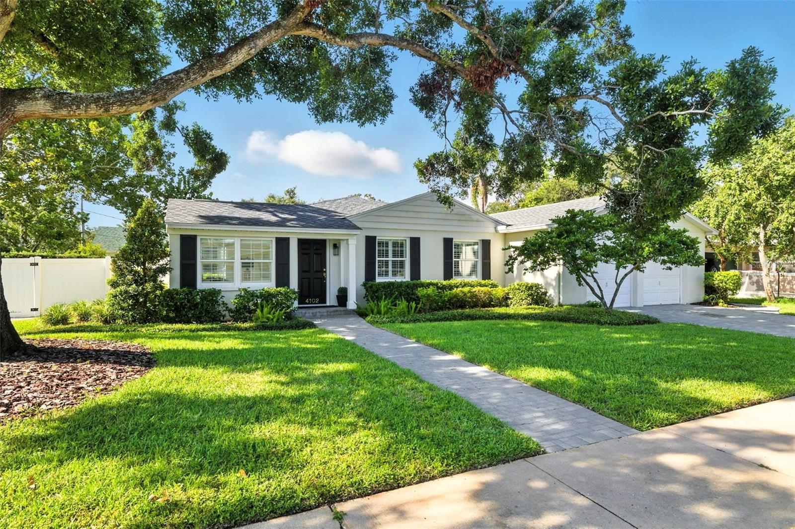This stunning South Tampa pool home sits on a 100 x 107 corner lot and is in flood zone X! Featuring 3 bedrooms, 2 1/2 baths, and a spacious office or den that could easily serve as a fourth bedroom. This beautifully updated one-story block home is ready to welcome its new owners. You'll immediately be drawn to the gorgeous, engineered oak flooring throughout, complemented by plantation shutters, and stylish light fixtures. The kitchen, tastefully renovated in 2020, boasts extended white cabinetry, pull-out drawers, luxurious gold hardware, a large white farmhouse sink, a dedicated wine and coffee bar with a beverage fridge, and an island with additional storage. A separate dining room offers the perfect setting for hosting intimate dinners. The family room, located just off the newly renovated kitchen, is bright and spacious, featuring French doors that open to the fenced backyard and pool area. The bedrooms are tucked away for added privacy, and the primary suite is a true retreat, highlighted by a spa-inspired bathroom renovation. It features a spectacular walk-in shower with dual shower heads, dazzling quartz countertops, dual sinks, built-in drawers with power outlets, and designer fixtures and finishes throughout. The large front office is ideal for working from home and also functions well as a playroom, gym, bonus room, or potential fourth bedroom. Outside, enjoy a large, heated pool and spa, a fully fenced yard, and a spacious side yard perfect for entertaining or outdoor play. Recent updates include a new roof (July 2024), all new windows (August 2025), 2 AC units (2016/2019), a freshly coated epoxy garage floor, and a newly paved driveway (2022). Located in the coveted school zones of Mabry, Coleman, and Plant, this home is just minutes from Palma Ceia Golf and Country Club, trendy local restaurants, Hyde Park Village, Bayshore Boulevard, Tampa General Hospital, Channelside, Armature Works, Amalie Arena, and everything South Tampa has to offer.