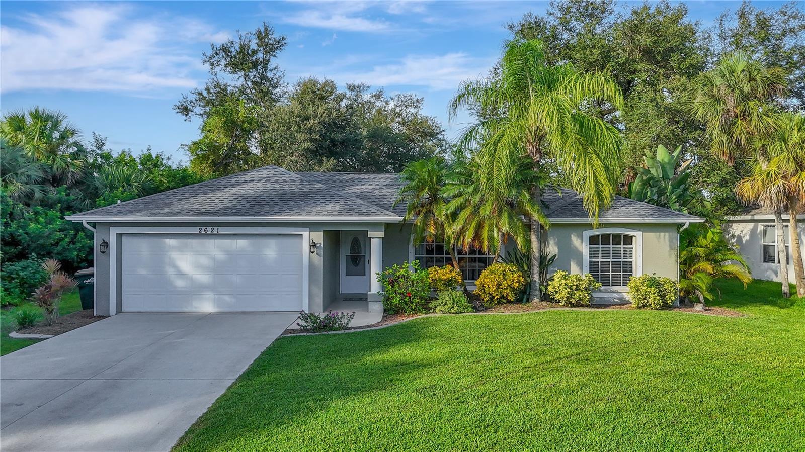***PLEASE TAKE A WALK THROUGH YOUR NEW HOME WITH THE 3D INTERACTIVE VIRTUAL TOUR*** Welcome Home to North Port Living! This lovingly cared-for 3 bedroom, 2 bath, 2-car garage POOL HOME is tucked into a quiet, desirable neighborhood where peace and charm meet everyday convenience. From the moment you pull up, you’ll notice the pride of ownership—lush green grass, curbing and tropical landscaping filled with palm trees, crotons, birds of paradise, and the soft fragrance of flowers that instantly make you feel at home. Step inside and you’re greeted with high vaulted ceilings and an open, airy floor plan that feels both spacious and welcoming. The oversized great room is filled with natural sunlight streaming through the front windows, creating a warm and inviting atmosphere for relaxing or entertaining. The heart of the home—the kitchen—boasts NEW stainless steel appliances (all included in the sale), closet pantry, abundance of cabinet and countertop space for all your culinary needs, and decorative plant shelves that add a touch of character. Just steps away, the dining area provides the perfect setting for sharing home-cooked meals with family and friends while overlooking your private backyard oasis. The master suite is a true retreat with ceramic tile flooring, a walk-in closet, and a private en-suite bathroom with shower. Two additional bedrooms are equally comfortable, and across the home in the split bedroom floorplan, each appointed with private closets, windows, and ceiling fans to ensure restful nights. The guest bathroom is conveniently placed, and includes a tub/shower combo and vanity, ideal for family or visitors. But the best part of this home? Step outside and experience the true Florida lifestyle! Sliding glass doors lead you to the covered lanai, perfect for sipping morning coffee or winding down at the end of the day. Beyond that, an open patio creates an inviting spot for grilling, gathering around a firepit, or simply enjoying the outdoors. Take a dip in your sparkling pool, relax in the above-ground hot tub, and let the kids or pets run freely in the fully fenced backyard. With dog doors already installed, your four-legged family members will love it just as much as you do! This home isn’t just a place to live—it’s a place to make memories. Whether you’re hosting summer barbecues, enjoying quiet evenings under the stars, or simply appreciating the peace of your neighborhood, this property has everything you need to feel right at home. Come see for yourself why this North Port gem is the perfect blend of comfort, warmth, and Florida charm. Schedule your showing today and get ready to fall in love!