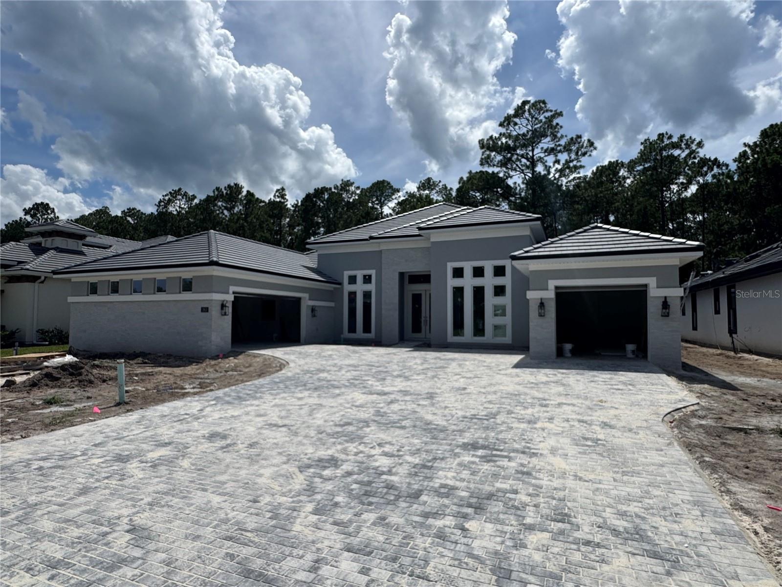 Under Construction. BRAND NEW HOME! Nearly Completed. Experience luxury living in the award-winning Egret II by ICI Homes—a beautifully crafted, single-story residence offering 3218 square feet of thoughtfully designed space perfect for both everyday living and elegant entertaining. Located in the prestigious Plantation Bay Golf & Country Club, this home features three bedrooms, three full bathrooms, a private study, and a three-car garage, making it ideal for those who appreciate both style and functionality. Step through the grand 12-foot entryway into a welcoming foyer flanked by a formal dining room and a private study with an arched window—setting the tone for the refined design throughout. The heart of the home is an expansive open-concept living area, where the gourmet kitchen, casual dining nook, and living room blend seamlessly under soaring tray ceilings. The chef’s kitchen includes a large center island, generous counter space, pantry, and premium finishes—perfect for hosting or daily living. Just beyond, sliding glass doors open to a spacious covered lanai, ideal for alfresco dining or relaxing in the Florida breeze. The luxurious owner's suite is tucked away at the back of the home for privacy and features tray ceilings, dual walk-in closets, and a spa-inspired bath complete with double vanities, a soaking tub, and a walk-in shower. Two additional bedrooms are located on the opposite wing of the home, each with access to a full bath—an ideal layout for guests or family. Enjoy high-end finishes throughout, a state-of-the-art clubhouse, and an array of top-tier community amenities. Celebrate the holidays in style—your dream home will be ready soon! Exclusive Incentive: Receive a substantial discount on initiation fees for membership of choice to the Plantation Bay Golf & Country Club provided buyers join within 30 days of closing. Peace of Mind Included. Comes with a comprehensive HBW Warranty for added assurance.