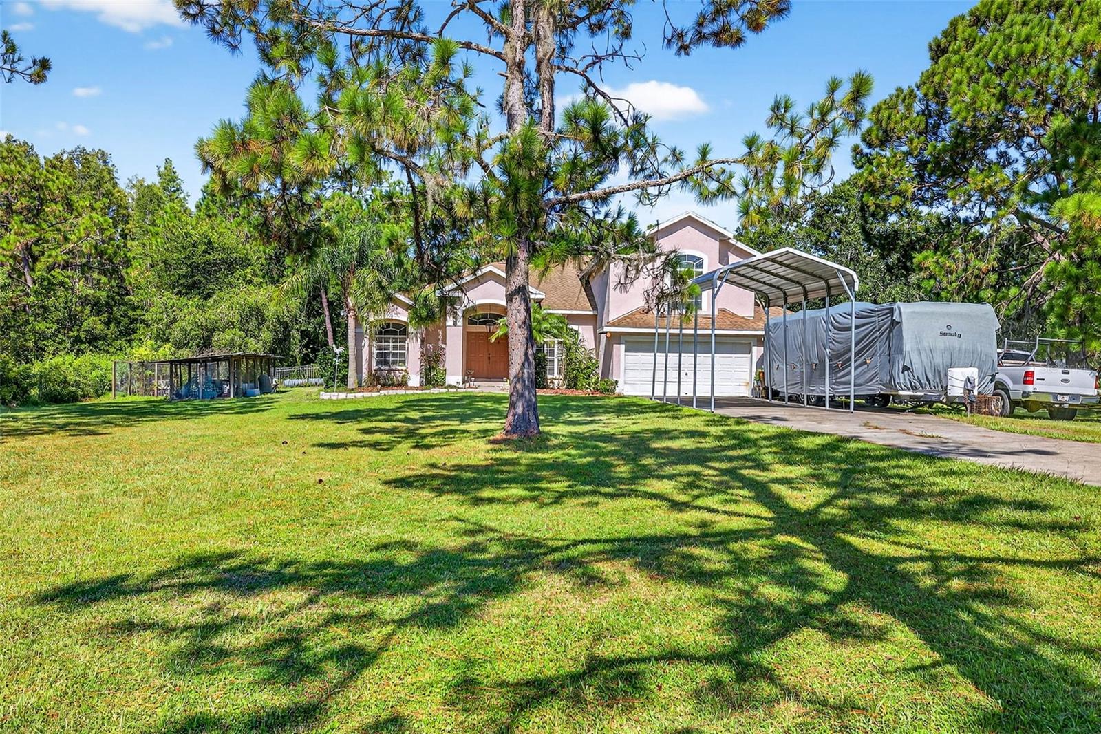 Welcome to Quail Hollow Pines, where country charm meets modern living. This stunning 4 bedroom, 3 bath pool home sits on 1.2 acres of beautifully balanced land—offering both mature trees for privacy and cleared open spaces perfect for outdoor activities. With no HOA and no CDD, you’ll have the freedom to truly enjoy your property, whether that means parking your RV or boat, gardening, or even keeping chickens.
Step inside through elegant double doors into a foyer with soaring ceilings that immediately set the tone for this spacious residence. At over 3,200 sq ft, the thoughtful layout includes:
A bonus room, office, and extra family room for flexible living
A spacious kitchen with tray ceilings, large dining windows, and plenty of room to gather
A cozy fireplace anchoring the living space
An extra-large owner’s suite with wood flooring, walk-in closet, and spa-like bath
A pool bath for easy access when entertaining outdoors
Enjoy Florida living at its best in the screened lanai and sparkling pool area, perfect for summer barbecues or relaxing evenings under the trees. The small fenced yard is ideal for pets, while the fully fenced property line offers both peace of mind and ample room to roam.
Located just minutes from The Grove at Wesley Chapel, you’ll enjoy shopping, dining, and entertainment nearby—while still tucked away in a private, non-city setting that feels like your own retreat.
This rare combination of space, freedom, and location is hard to find in Wesley Chapel. Don’t miss your chance to call it home!