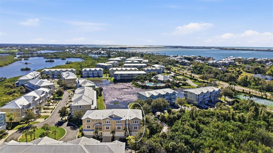 Welcome to resort-style living on Florida’s beautiful Cape Haze Peninsula, where location, lifestyle, and luxury come together in this stunning Bahamian-inspired townhome. If you’re searching for a maintenance-free home near Boca Grande and Manasota Key, with space for all your toys and access to world-class boating, fishing, and beaches—this is it.

Perfectly oriented to the southwest, this home captures breathtaking sunsets that change nightly, creating a peaceful coastal backdrop you’ll never tire of. A rare four-car garage with a recently epoxied floor offers ample space for vehicles, golf carts, water toys, or a workshop—an exceptional feature in today’s market. From the garage, enjoy the convenience of a private in-unit elevator or take the architecturally striking staircase to the main living level.

The heart of the home is the expansive open-concept living area, designed for both relaxed everyday living and effortless entertaining. The kitchen is a true showstopper, featuring one-of-a-kind leathered granite countertops, a large center island, abundant cabinetry, stainless steel appliances, and a sleek glass backsplash. Whether hosting guests or preparing a quiet dinner at home, this kitchen blends beauty with functionality.

Step outside to the spacious lanai, where a newly installed fan enhances comfort as you take in tranquil views of a large water feature. The privacy and serenity offered here are second to none, making this outdoor space an extension of your living area and the perfect place to unwind after a day on the water.

Back inside, a versatile flex room on the main level can be tailored to your needs—ideal as a third bedroom, home office, fitness room, or media space. Neutral luxury vinyl flooring completes the space and continues throughout the home, replacing the former carpet for a clean, modern feel.

The top floor features two generously sized primary suites, each with large walk-in closets and well-appointed en-suite bathrooms. Both bathrooms showcase matching custom leathered granite countertops, dual vanities, and thoughtful finishes. Low-E, hurricane-resistant PGT windows and sliding doors provide peace of mind, energy efficiency, and abundant natural light throughout the home.

Major mechanical updates include a new A/C system installed in 2023 and a water heater replaced in 2022, adding value and long-term reliability for the next owner.

Located in the highly desirable Landings at Coral Creek, this gated, resort-style community offers an impressive lineup of amenities, including a large clubhouse, fitness center, pickleball courts, heated pool and spa, and a scenic pier with kayak launch into Coral Creek—perfect for paddling, fishing, and exploring nearby waterways.

All of this is just minutes from the world-renowned beaches of Boca Grande and Manasota Key, along with marinas, golf, dining, and endless outdoor recreation. Whether you’re seeking a full-time residence, seasonal retreat, or investment opportunity, this home delivers the ultimate Florida coastal lifestyle.