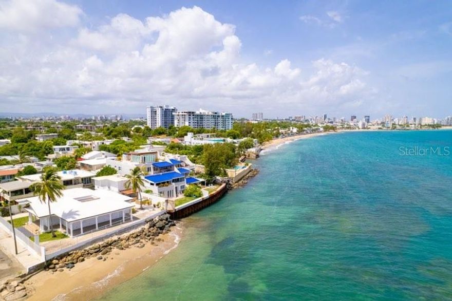 Villa Mare is a century-old dwelling that has steadfastly watched over this privileged oceanfront spot of 1,122 sq. mt. in Punta Las Marías, one of the most beloved seaside communities in town, featuring controlled access and nighttime security patrols. The property's most recent renovation, completed in 2020, stayed true to the original architectural style, evoking a nostalgic era of Caribbean elegance and carefree living in a classic bungalow setting.
The heart of the home is its central courtyard, whose gravitational pull draws people together as sunlight and moonlight filter through, enriching the indoor ambiance. Wraparound porches invite you to immerse yourself in the beauty of the sea and sky, while the gentle lullaby of the West Indies trade winds beckons you to a peaceful siesta.
For entertaining or relaxing, the outdoor bar and jacuzzi provide the perfect setting for gatherings with family and friends. Additionally, a two-bedroom, one-bath guest house offers comfortable accommodations for your visitors.