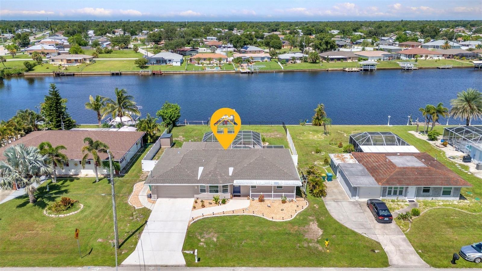 BEAUTIFUL SUNSETS & BOATER’S PARADISE! This stunning remodeled 4-bedroom, 2-bath waterfront SALTWATER POOL home with Gulf access is calling your name! Boasting 1,932 sq feet of comfortable living space under air, featuring 8-ft ceilings and a bright, open layout perfect for both relaxing and entertaining. Located on 80 feet of waterfront, you'll enjoy a new composite dock with electric & water hookups, a 7,500 lb boat lift and direct harbor access with two bridges out, this is truly a boater’s dream. Inside, a flexible bonus room with a charming bay window serves perfectly as a 5th bedroom, or office. The updated kitchen features quartz countertops, newer cabinetry, a stylish subway tile backsplash, stainless steel appliances, a closet pantry with a barn door, and modern laminate flooring throughout the home. The living and dining spaces flow seamlessly through the French doors onto your screened lanai and pool area-ideal space for indoor-outdoor Florida living. The primary bedroom offers a tranquil retreat, with private access to the pool and lanai, along with a spacious walk-in closet. The en-suite bathroom offers a tiled walk-in shower with a Vevor multi-function shower panel and a modern vanity. All guest bedrooms feature built in closets, and the expansive fourth bedroom has direct access to the lanai—perfect for guests or a private retreat. The guest bathroom features a single sink and a shower/tub combo. Laundry is conveniently located in the garage and washer & dryer are included. Outdoor living at its best, the oversized SALTWATER pool and lanai provide the perfect setting for entertaining and enjoying breathtaking sunsets. Boating and fishing enthusiasts will love the waterfront adventures just a short boat ride away. The fully fenced yard includes a shed with a wood platform for your outdoor needs. Enjoy peace of mind with numerous updates in 2025: NEW SEPTIC SYSTEM, Laminate Flooring, SALTWATER Pool System, Refrigerator and Variable-Speed Pool Pump. 2024: Two Boat Lift Motors, Boat Bunks, Composite Dock Decking, Nest Thermostat, 50 AMP RV Hookup, Shed, AC CONDENSER, Fencing, Garage Door Opener, and Microwave. 2023: Impact Windows, ROOF, AC HANDLER, Gutters, Hot Water Heater, Interior/Exterior Paint including driveway and lanai. 2022: Pool Cage Rescreened. 2015: Plumbing Fully Re-Piped. City water, lush landscaping, and a great location close to US-41, beaches, dining, shopping, and more make this property truly special. Don't miss the chance to make this waterfront paradise your own. Schedule a viewing today and let your dream home become a reality!