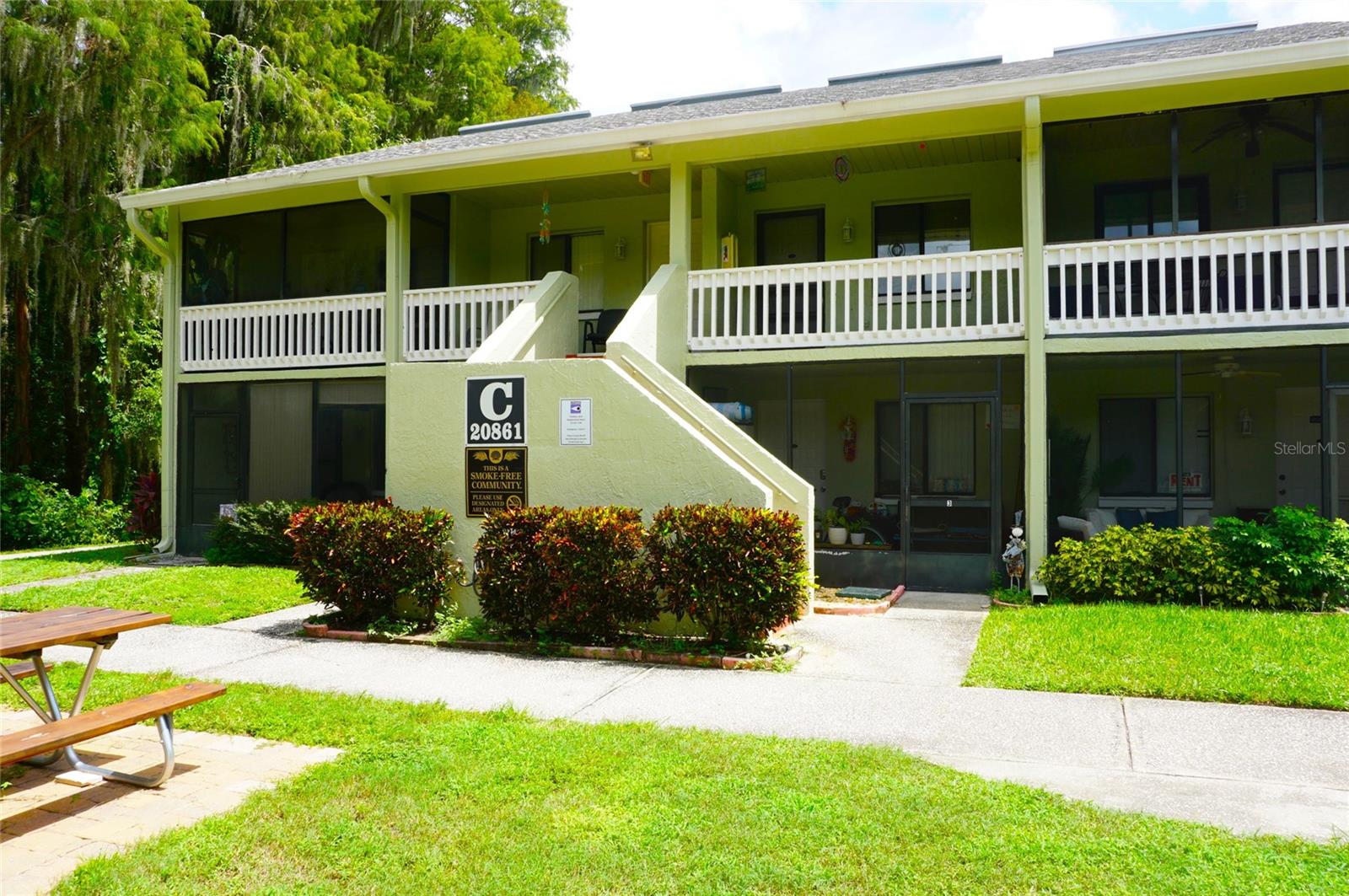 Outstanding opportunity to own a piece of Paradise! This furnished 1-Bed/1-Bath condo is located in the gated nudist/clothing-optional community of Paradise Lakes. Tile and stone flooring and neutral colors throughout. Kitchen features stainless sink, 4-burner range, counter microwave, refrigerator, and extra pantry cabinets. Roomy living space with electric fireplace and mirror accent wall. Primary bedroom has a built-in desk, closet, and utility storage. Vaulted ceilings and loft give this condo an airy feel. Full bath with tub-shower combination and raised height vanity. AC replaced four years ago. Building C is located a short walk from the community pier, deck, and lake. Existing furnishings, appliances, and decor included. Buyer is responsible for verifying all information, details and dimensions. Condo association approval of Buyer is required including application, fee, background check, orientation, and membership in a recognized nudist organization. Optional membership to Paradise Lakes Resort not included in the monthly condo association fee.