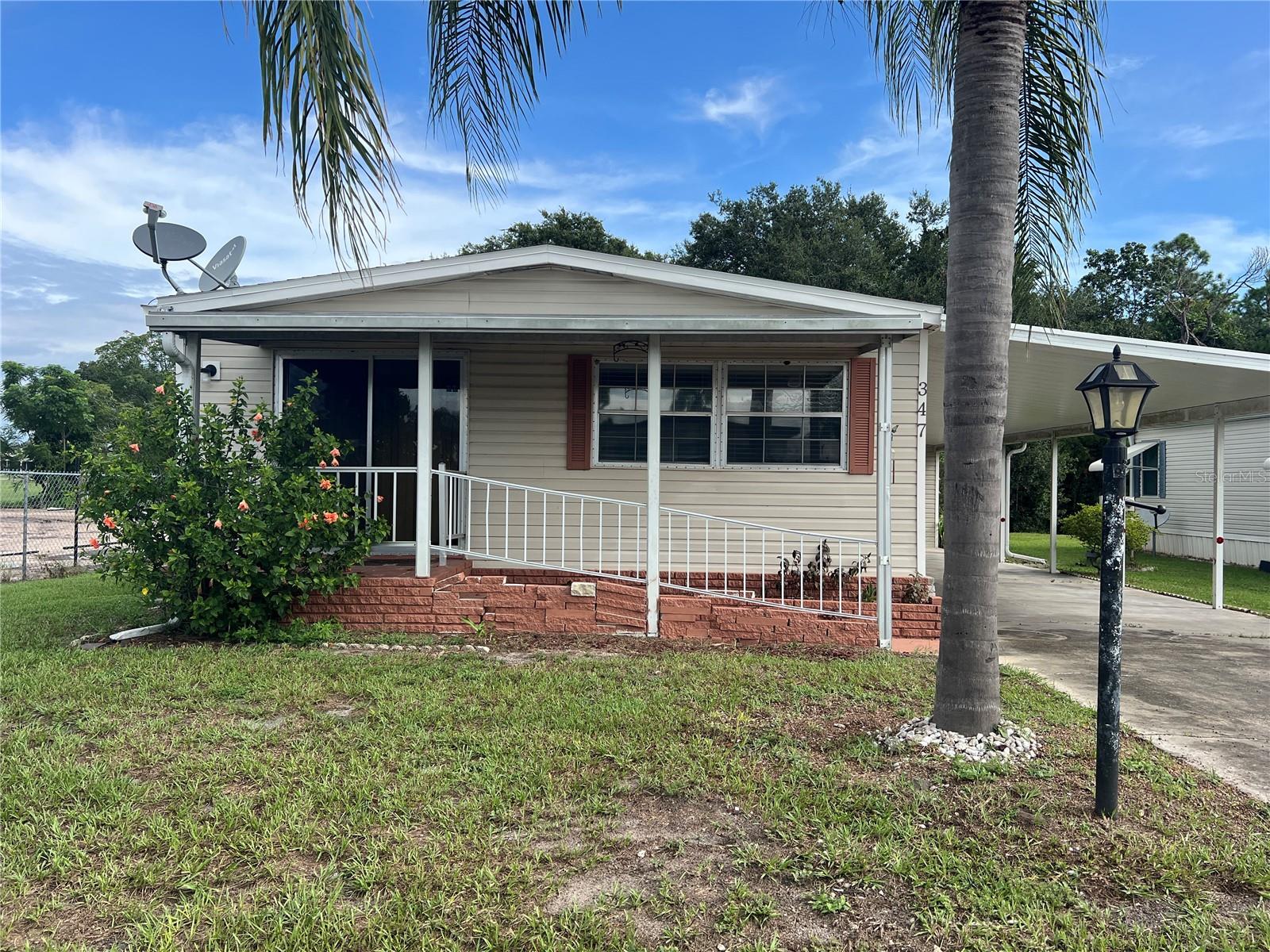 Own your land with no HOA in Caloosa Lake Village! This 2 bedroom, 2 bathroom double-wide mobile home is located in Caloosa Lake Village, where you own your land with no monthly fees. Inside, the home offers a larger master bedroom and multiple living areas, giving you flexibility for your layout and lifestyle. The kitchen includes a built-in double oven, and the washer and dryer are conveniently located inside the home. A spacious 11x36 back porch runs the full width of the home off the master bedroom. It connects directly to the attached storage shed, which sits off the carport. There is also a large additional shed that provides even more space for storage or a workshop. The home does need some repairs, but it’s a great opportunity for anyone handy or looking for a project to customize to their liking.